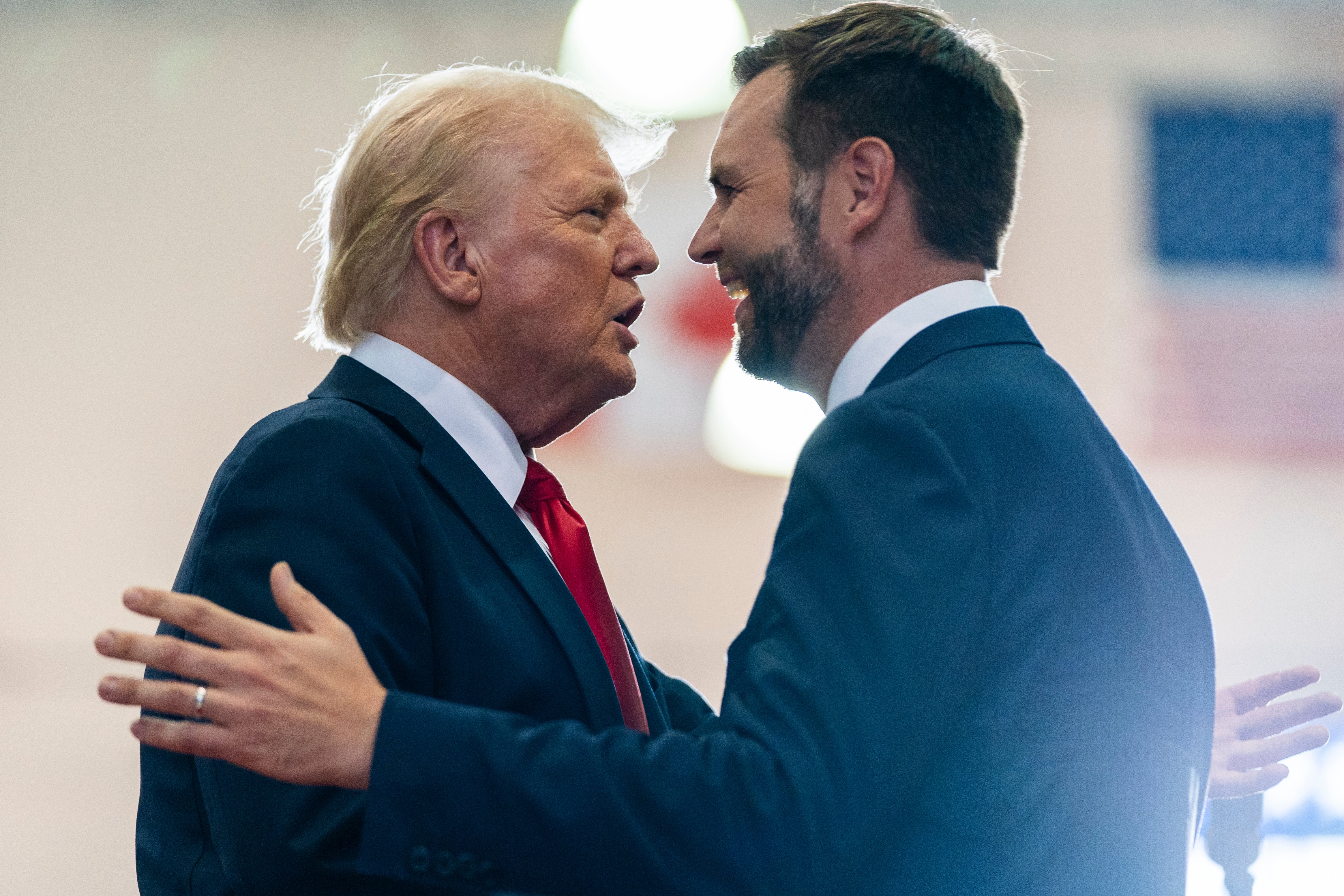 Republican presidential candidate former President Donald Trump, left, greets Republican vice presidential candidate Sen. JD Vance, R-Ohio, before speaking at a campaign rally in Minnsota