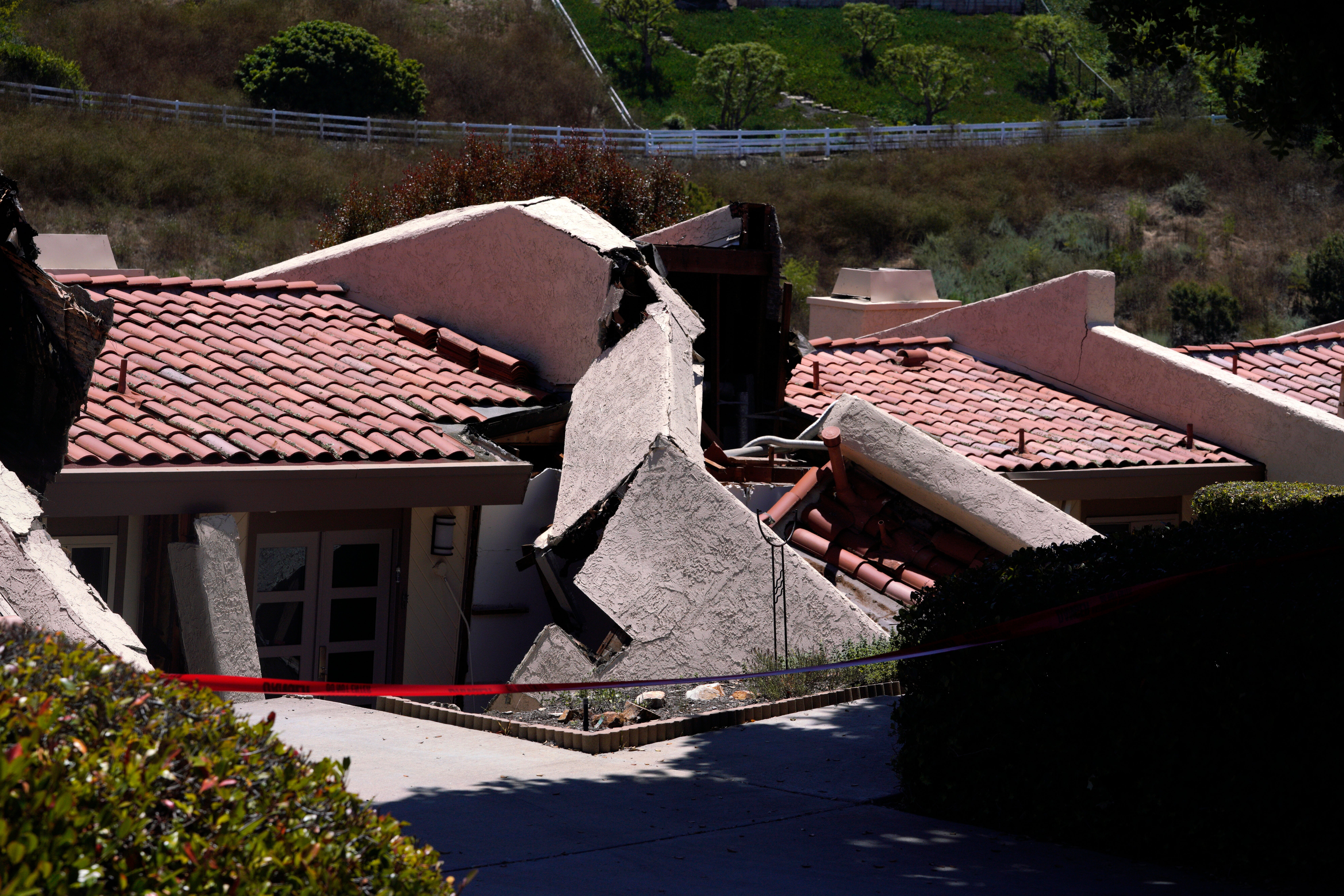 A roof of a house in Rolling Hills Estates is severely damaged after a landslide on the Palos Verdes Peninsula in Los Angeles County on Monday 10 July 2023