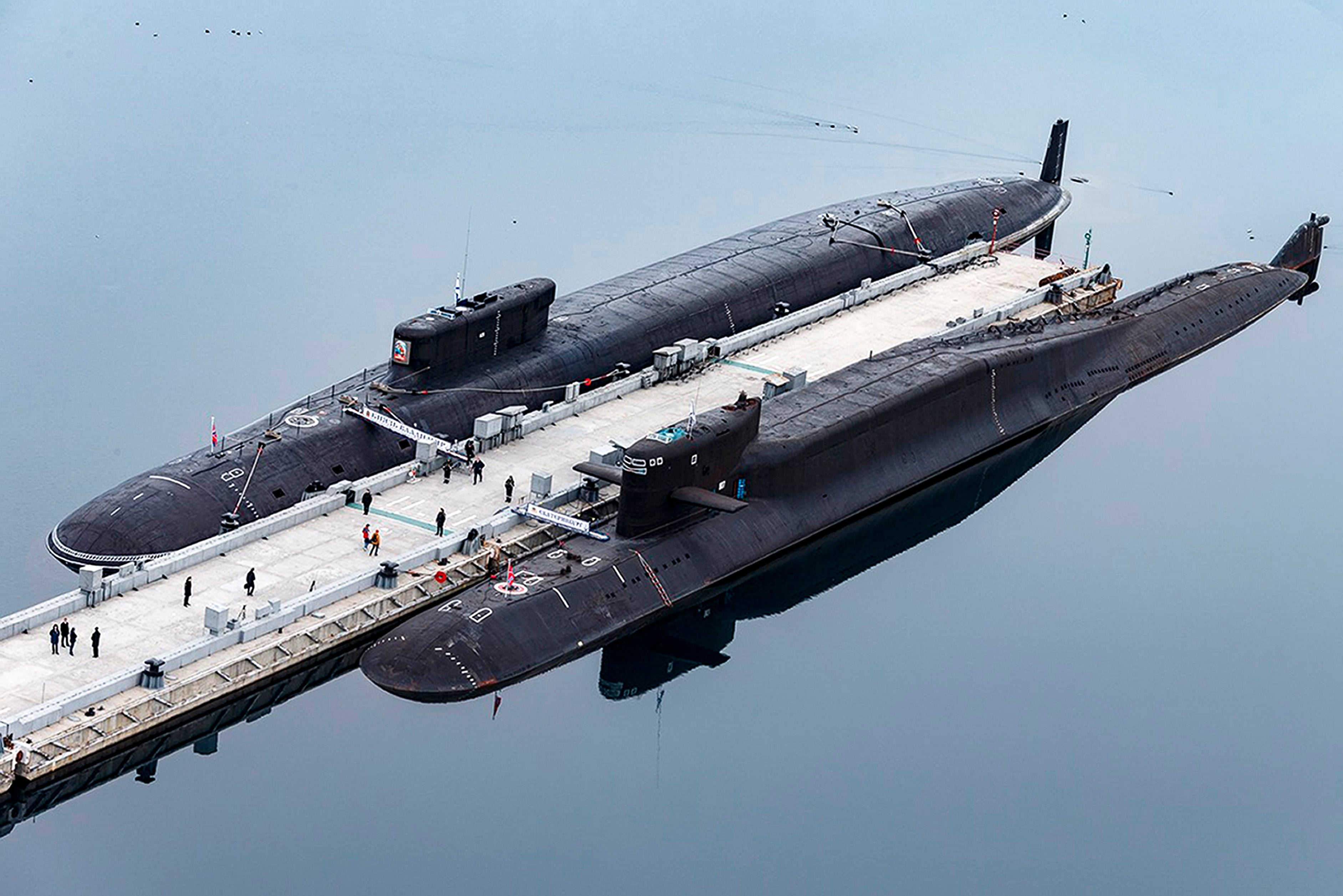 In this photo released by the Russian Defense Ministry Press Service, the Russian nuclear submarines Prince Vladimir, above, and Yekaterinburg are harbored at a naval base in Gazhiyevo, on the Kola Peninsula in Russia, on April 13, 2021