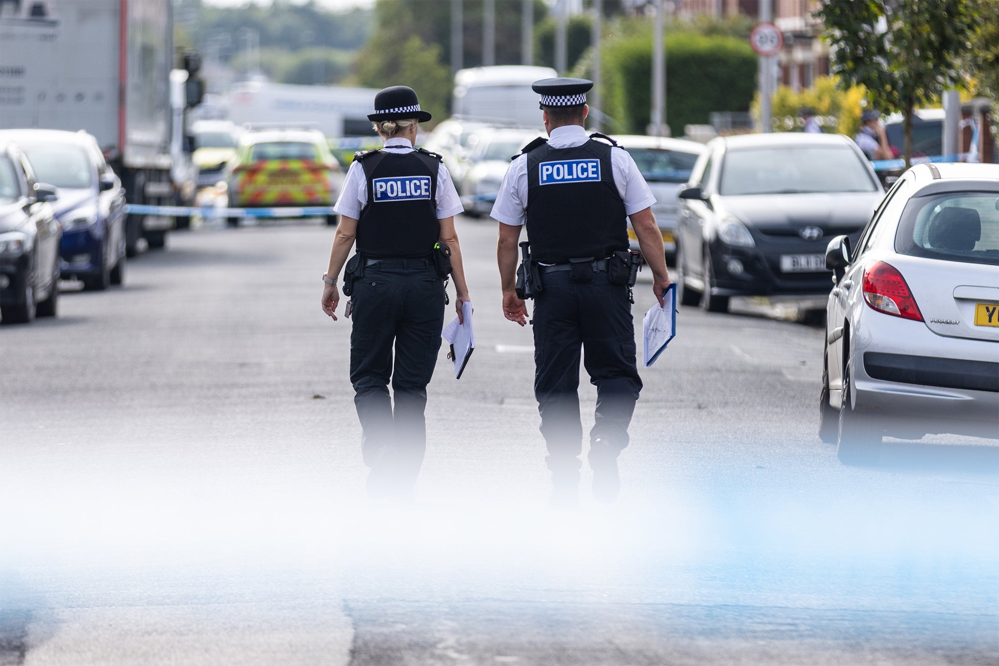 Police officers near the scene of the knife attacks in Hart Street, Southport