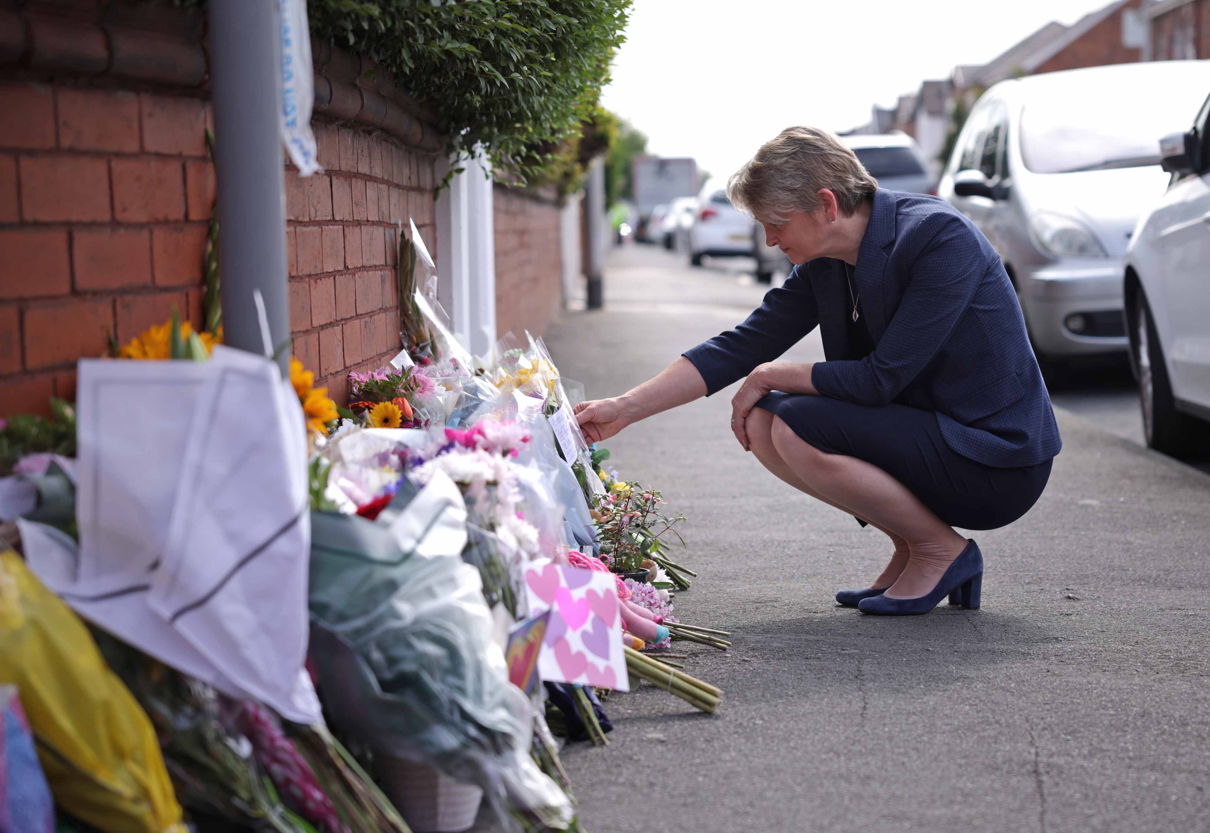 Home Secretary Yvette Cooper looks at tributes near the scene in Hart Street