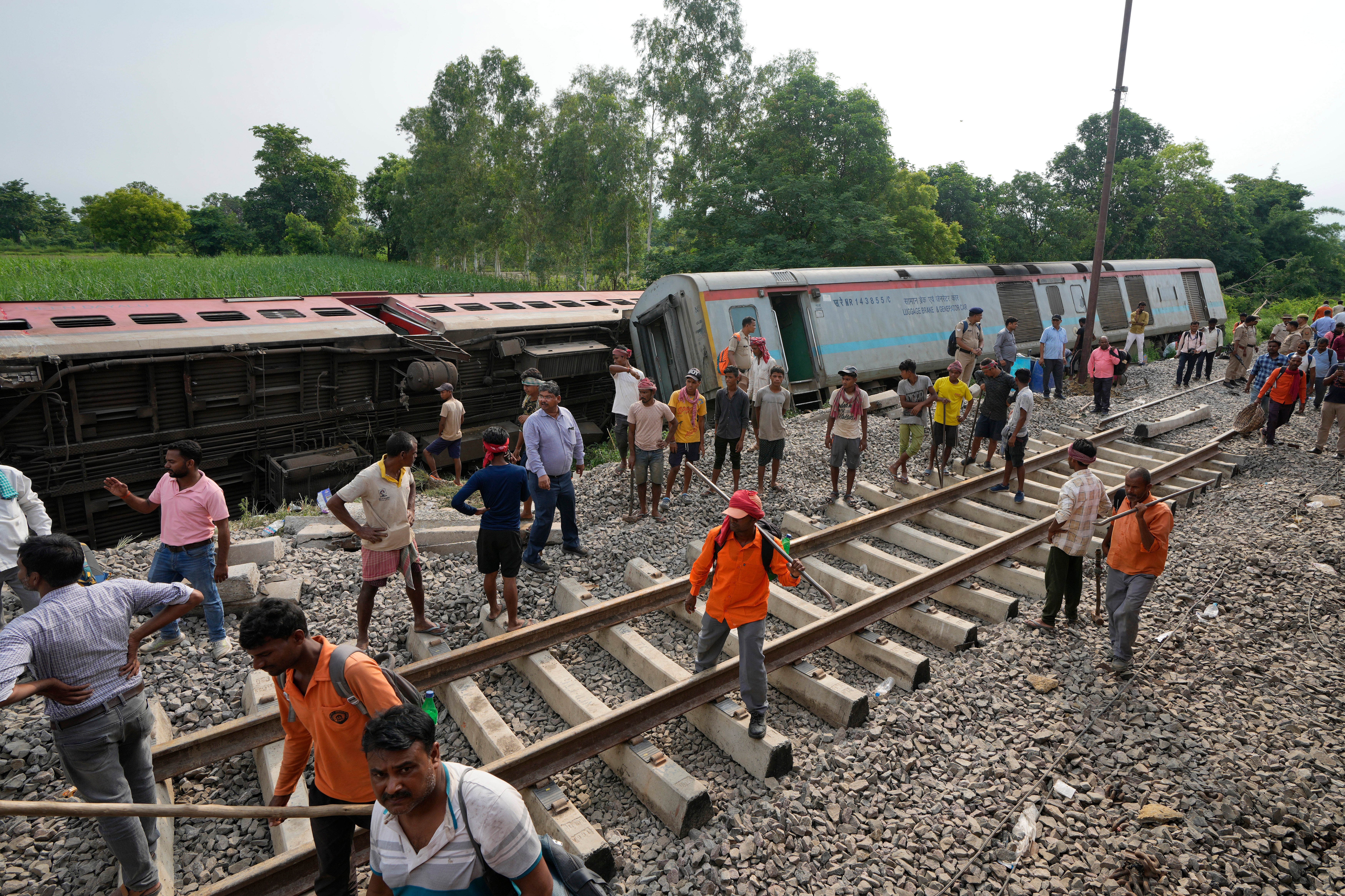 A crew prepares to repair railway tracks after an accident in Uttar Pradesh, India