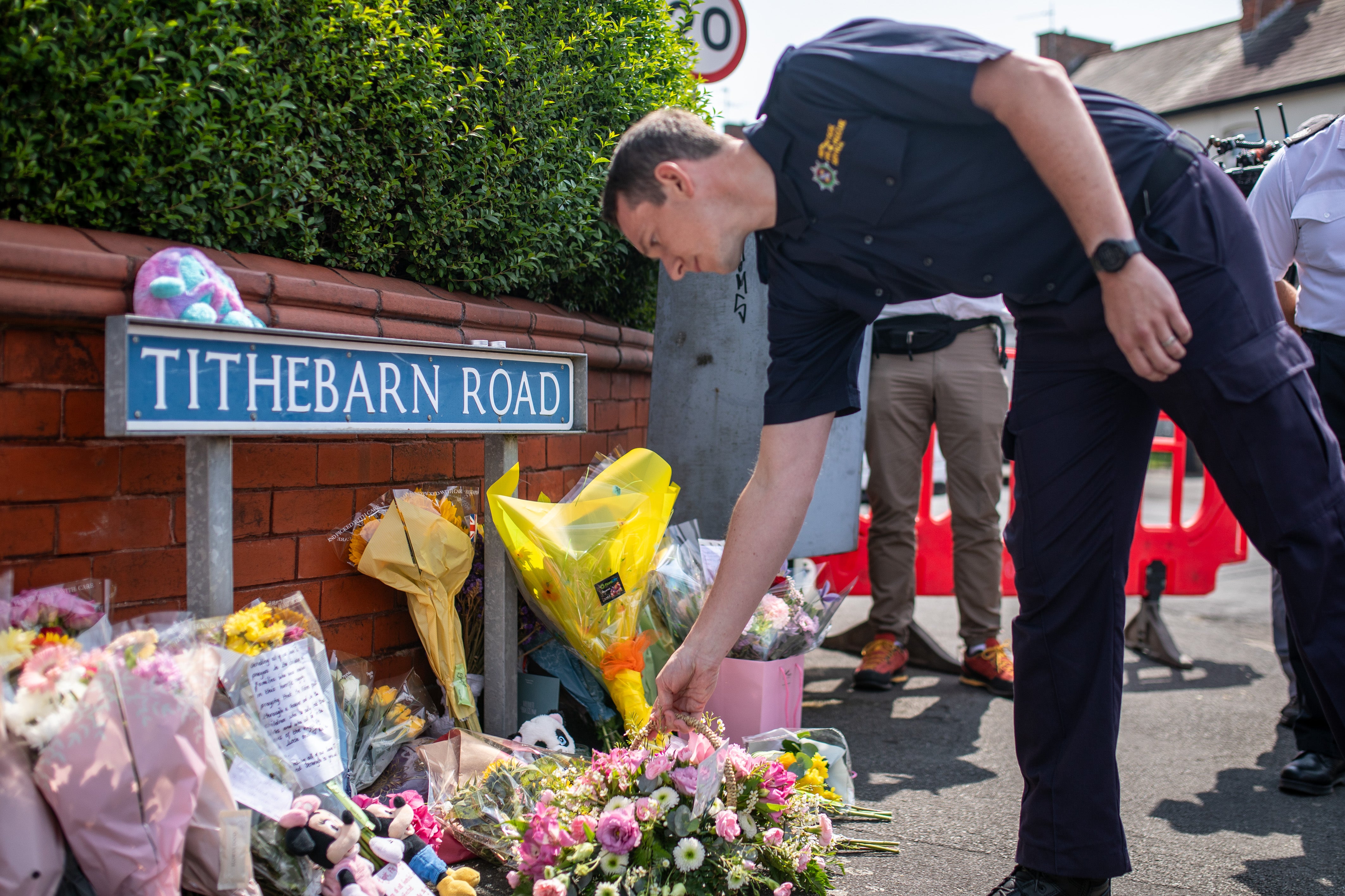 Emergency services workers laid flowers near the scene in Hart Street, Southport,