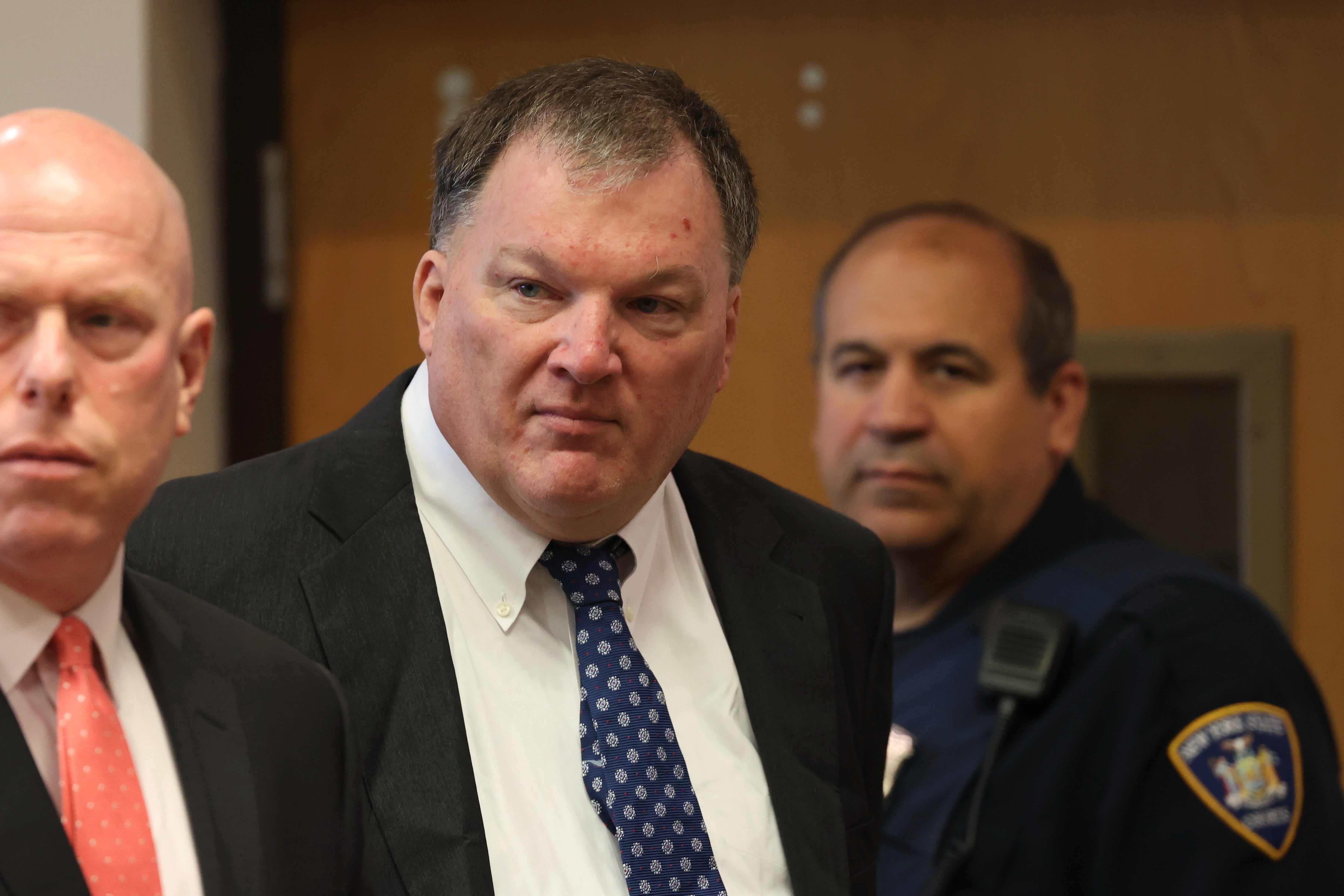 Rex Heuermann, center, charged in the Gilgo Beach serial killings on Long Island, appears for a hearing, Tuesday, July 30, 2024, at Suffolk County Court in Riverhead, N.Y. He’s been charged in the deaths of six women