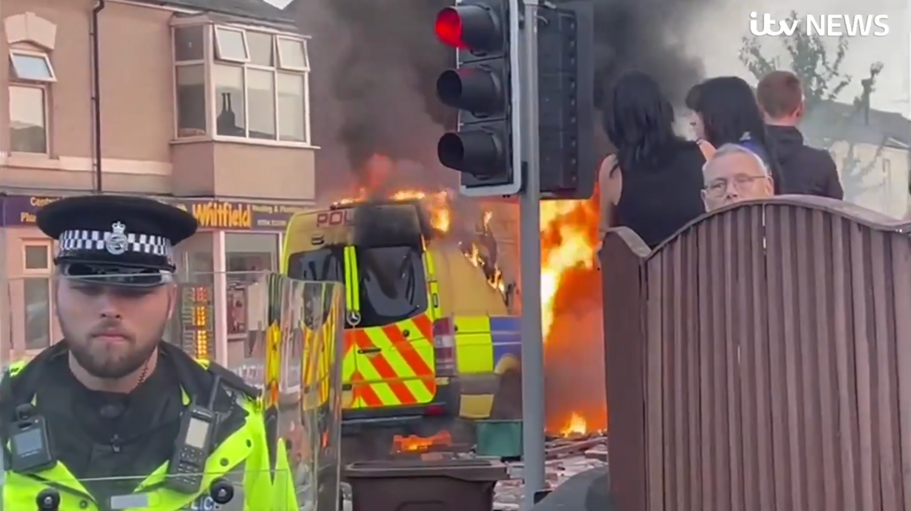 Flames engulf a police van during a violent protest