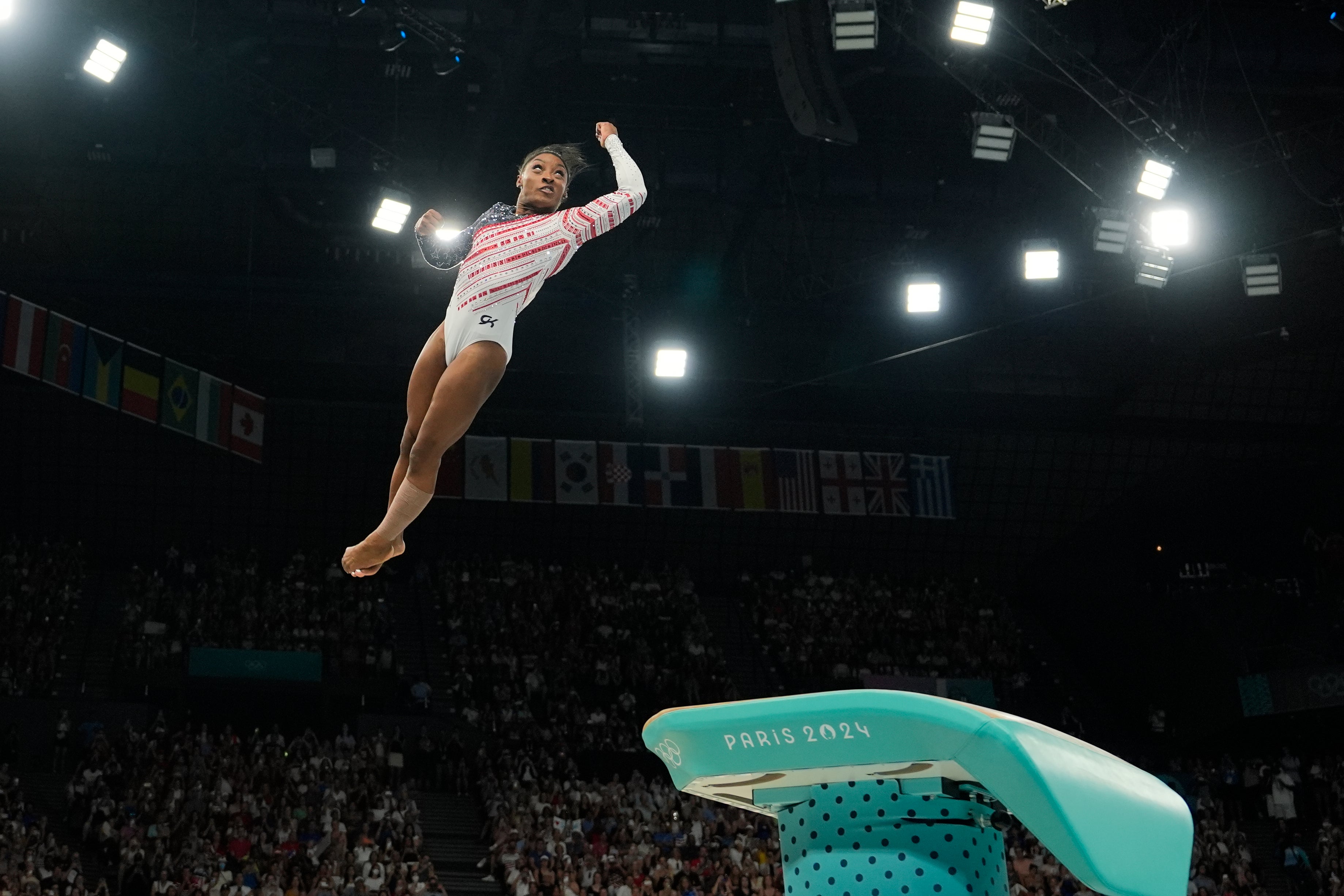 Simone Biles flies through the air during the team competition