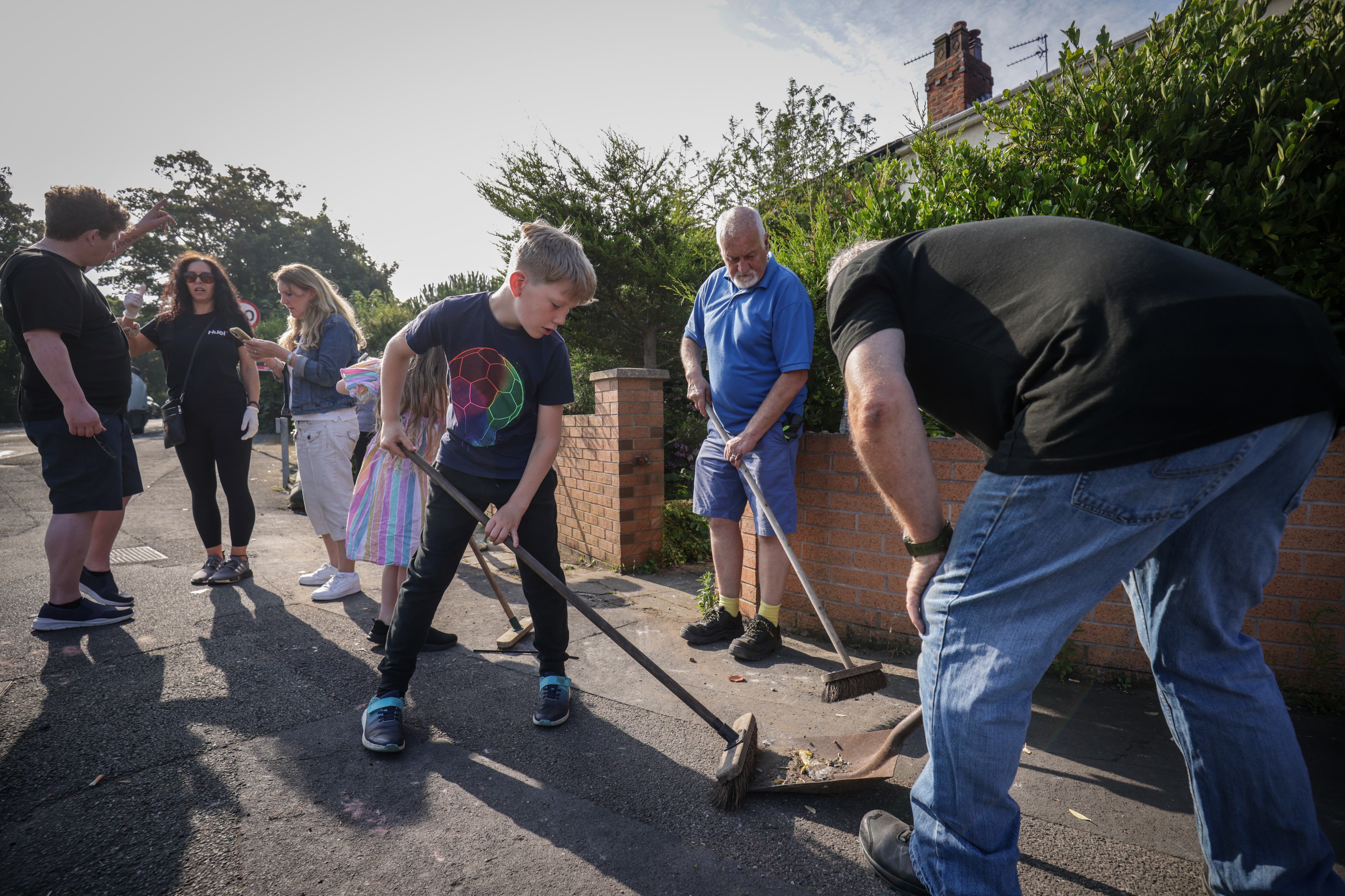 Volunteers sweep Sussex Road in Southport, Merseyside (James Speakman/PA)