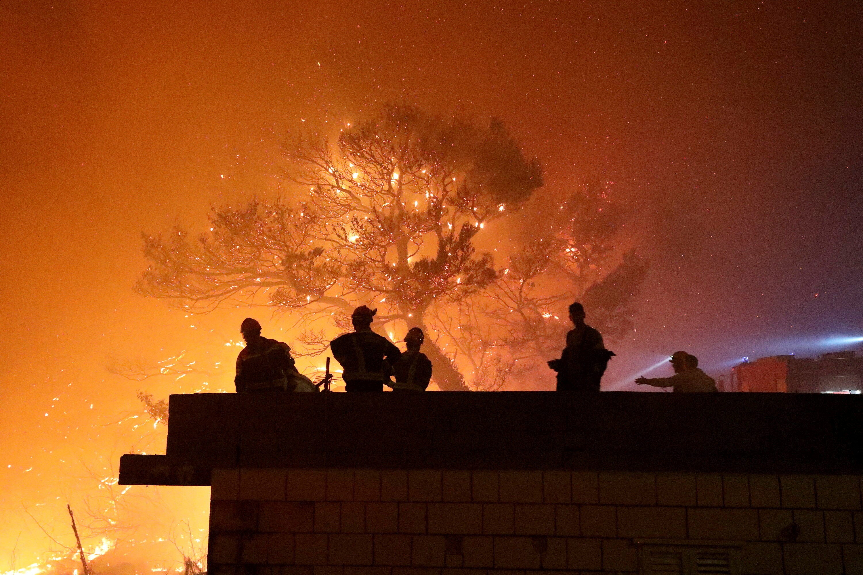 Firefighters gather near the wildfire in Tucepi, Croatia, late Tuesday, July 30, 2024