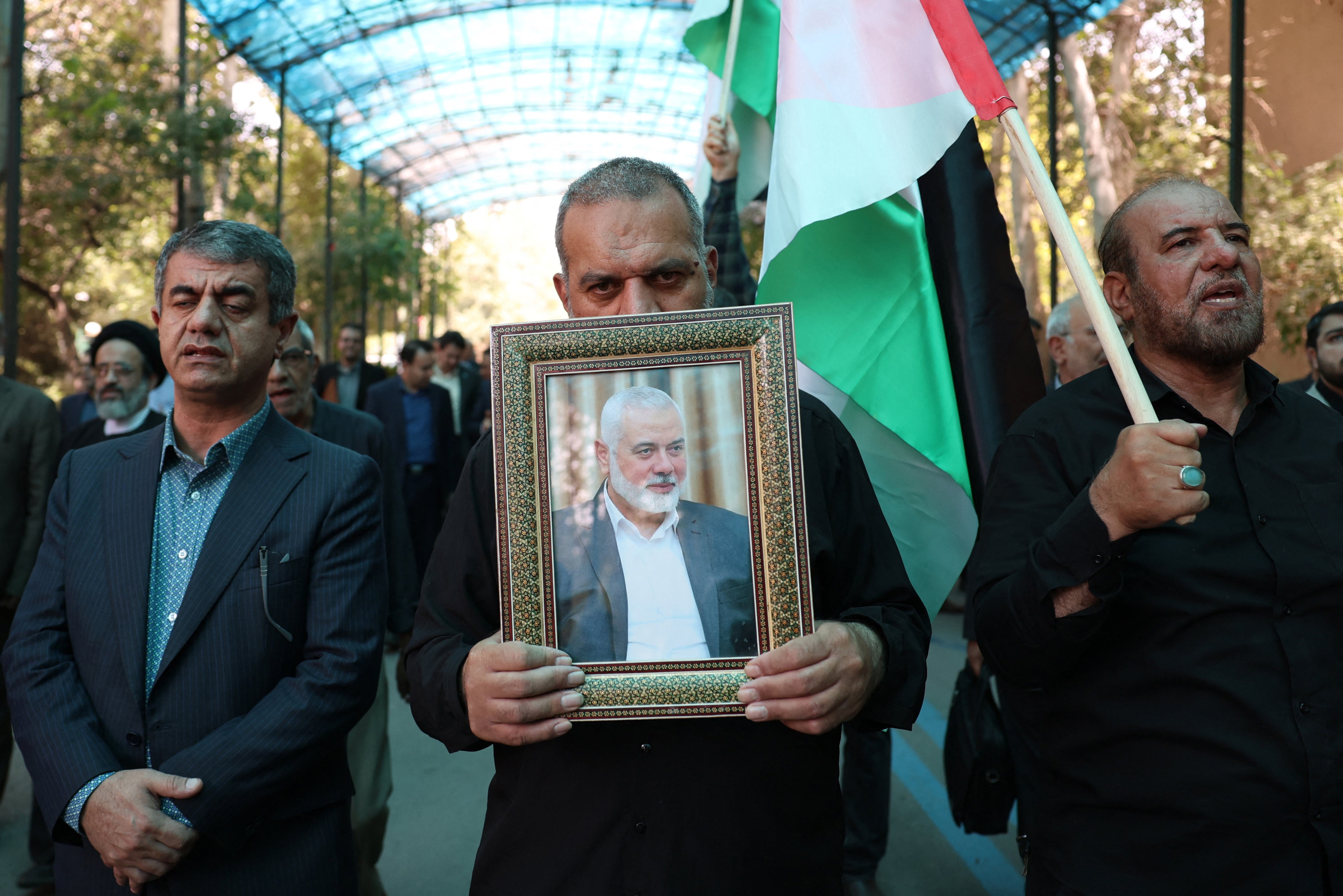 Demonstrators with a portrait of assassinated Hamas chief Ismail Haniyeh in Tehran