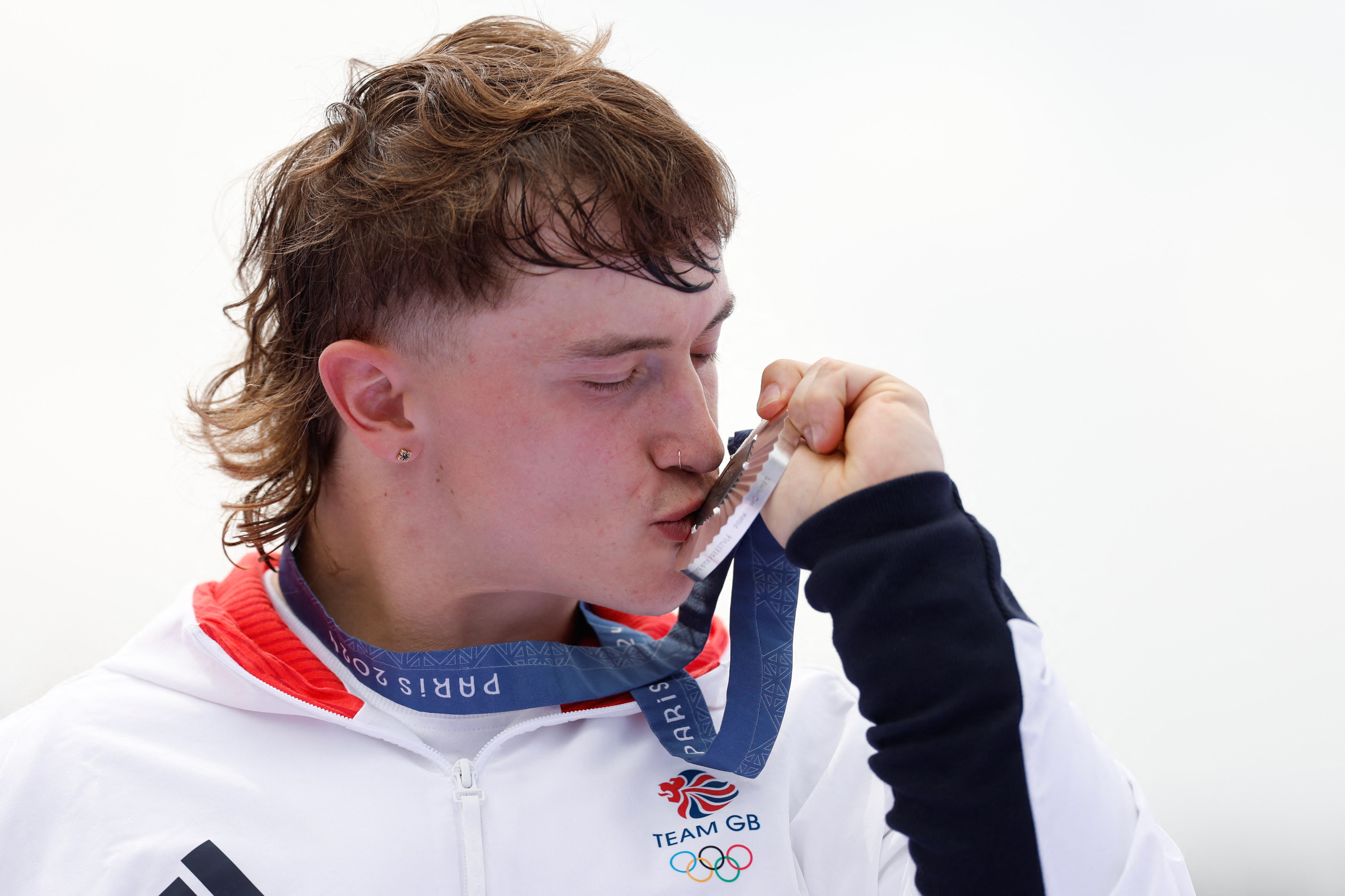 Britain's Kieran Darren David Reilly kisses his silver medal