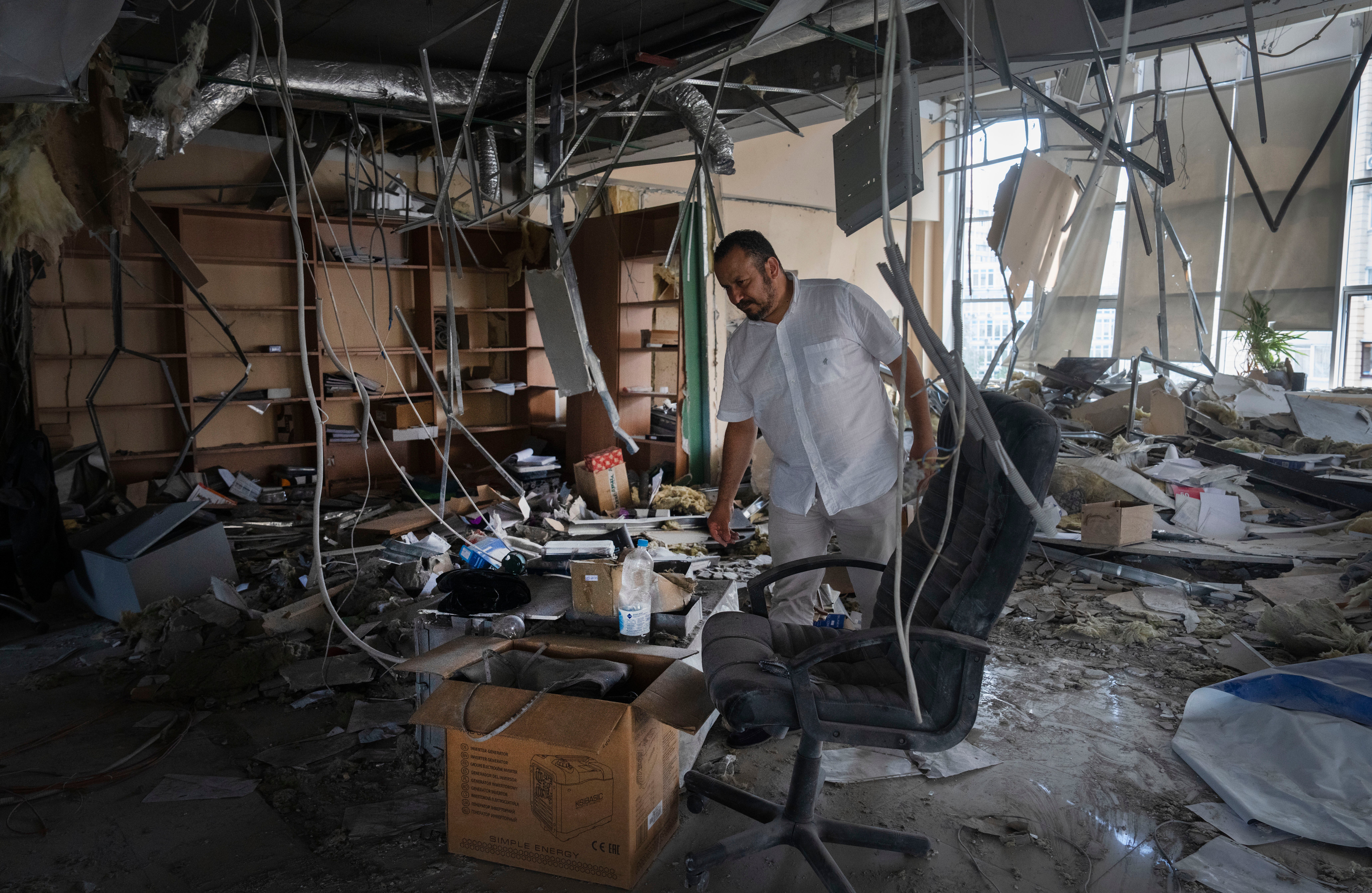 Alya Gali, a Gaza Strip-born doctor, looks at damaged equipment standing amid debris two weeks after a missile killed nine when it hit a private clinic where he has worked for most of his professional life in Kyiv, Ukraine