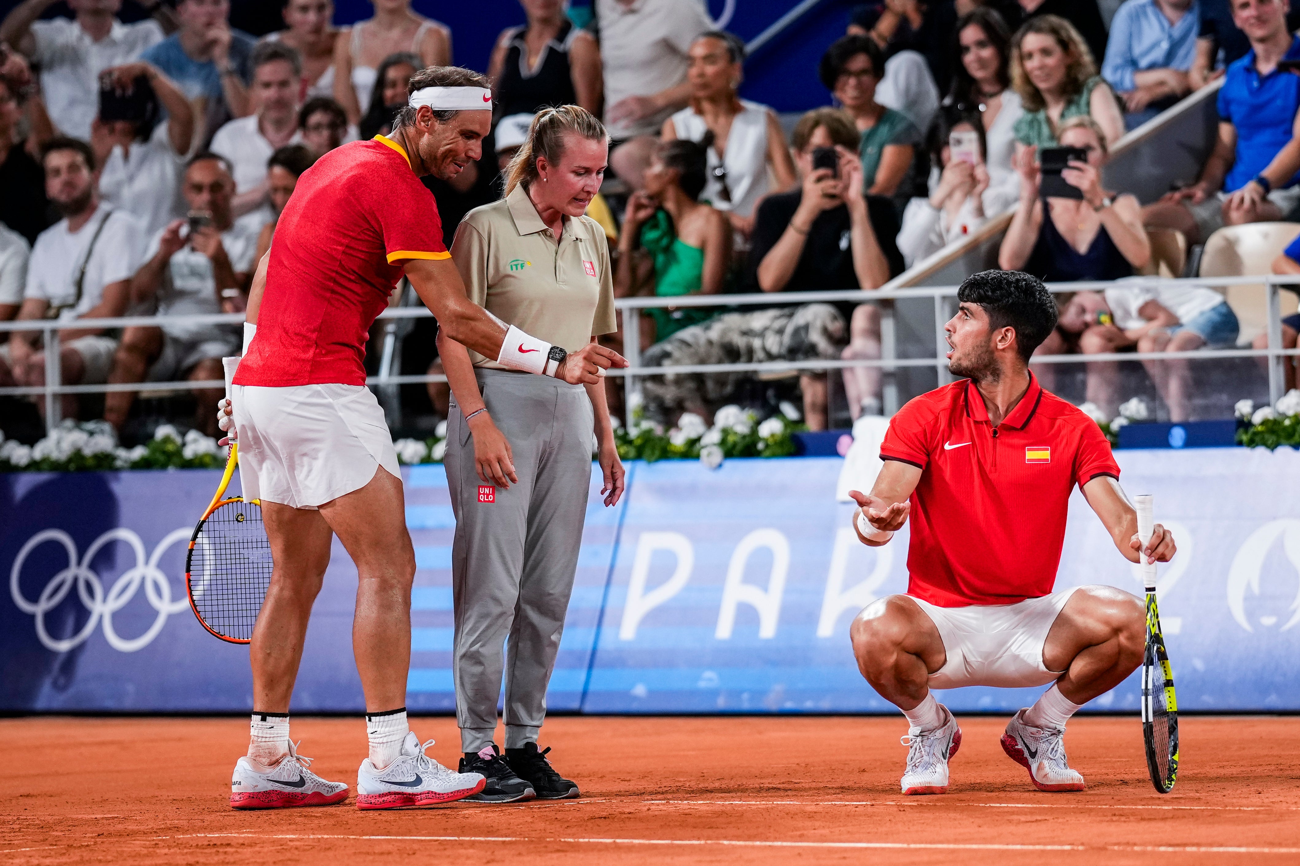 Rafael Nadal, left, and Carlos Alcaraz of Spain argue over a referee decision