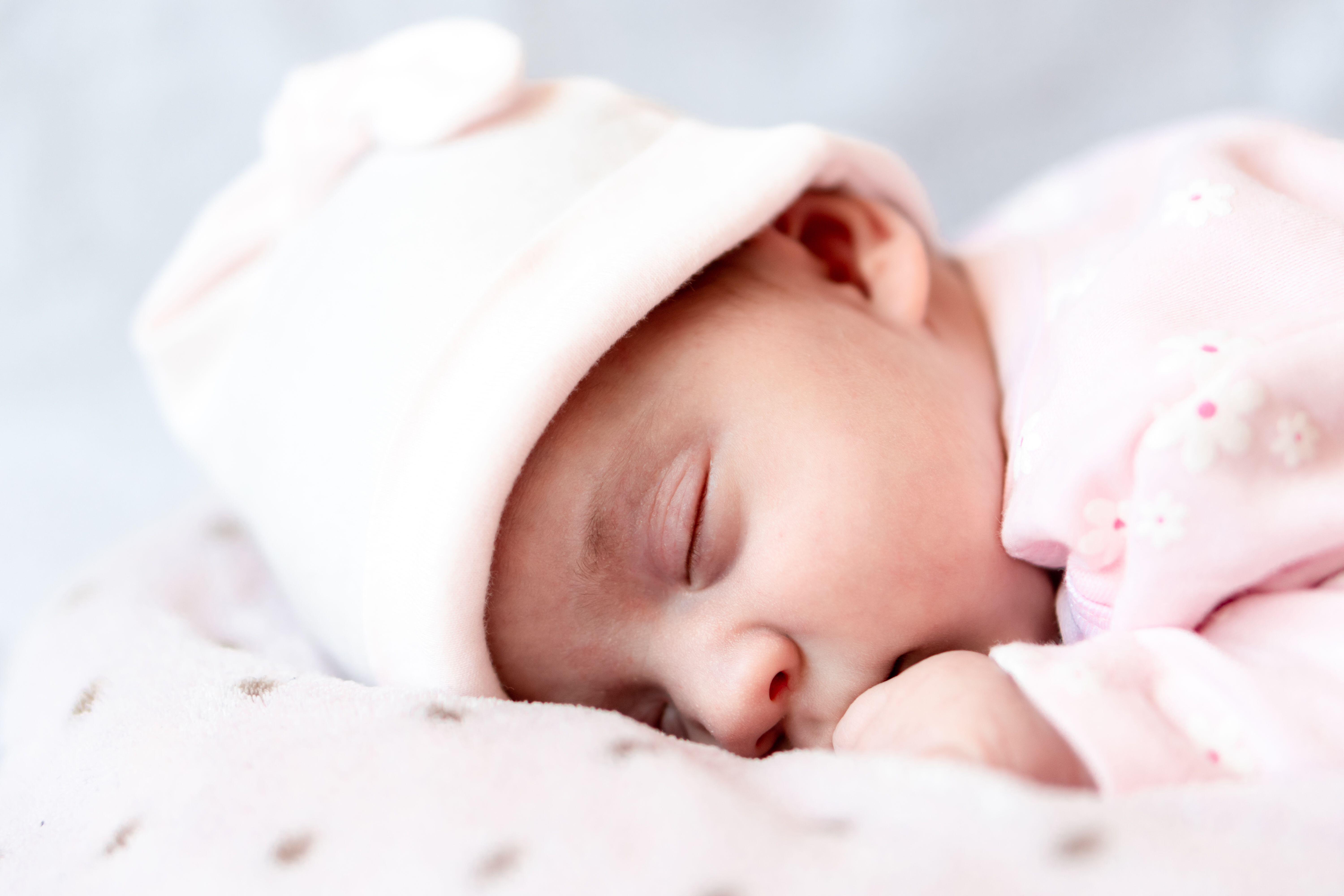 Baby wearing hat sleeping face down