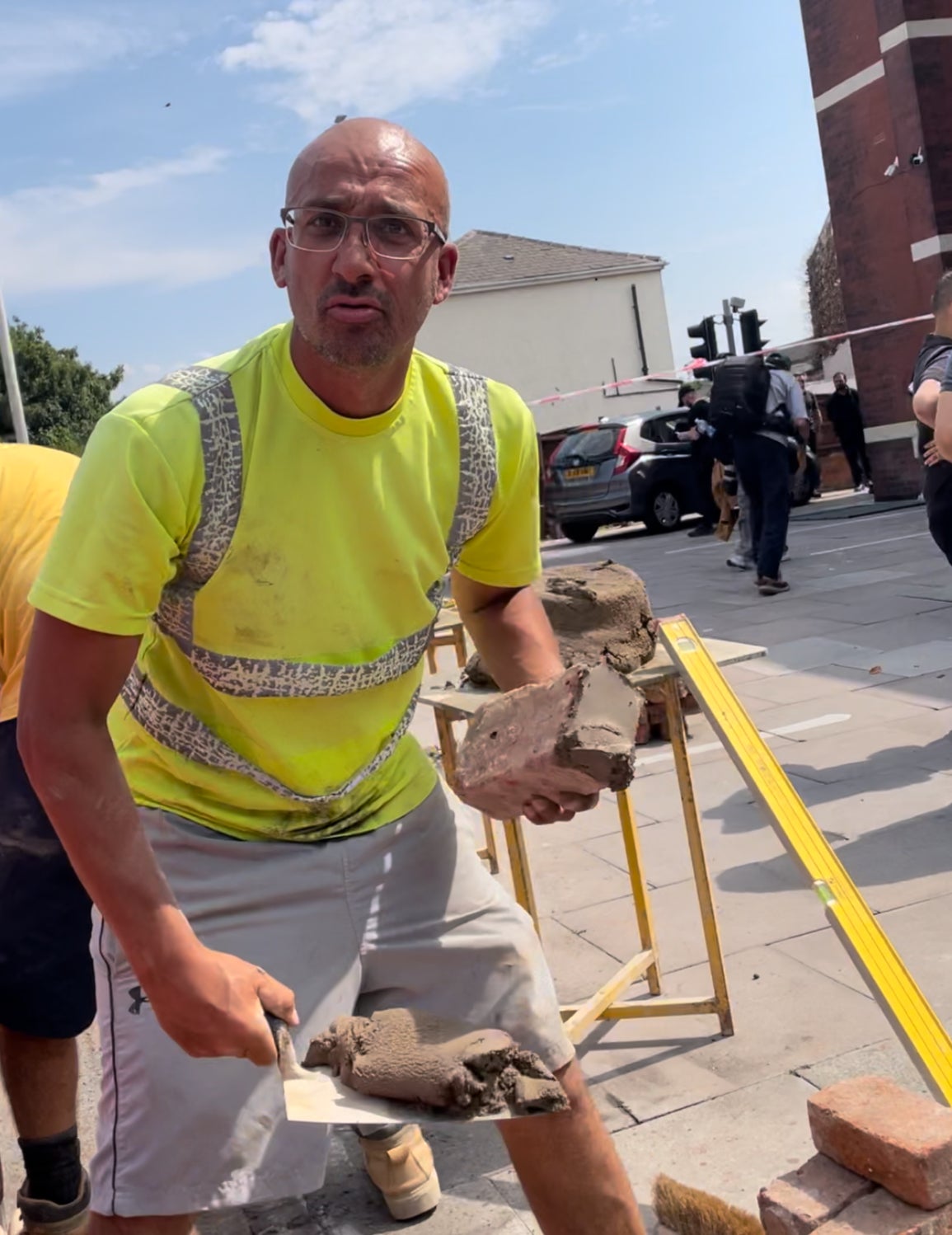 Tony Hill working in the blazing sun to fix the mosque wall in under three hours