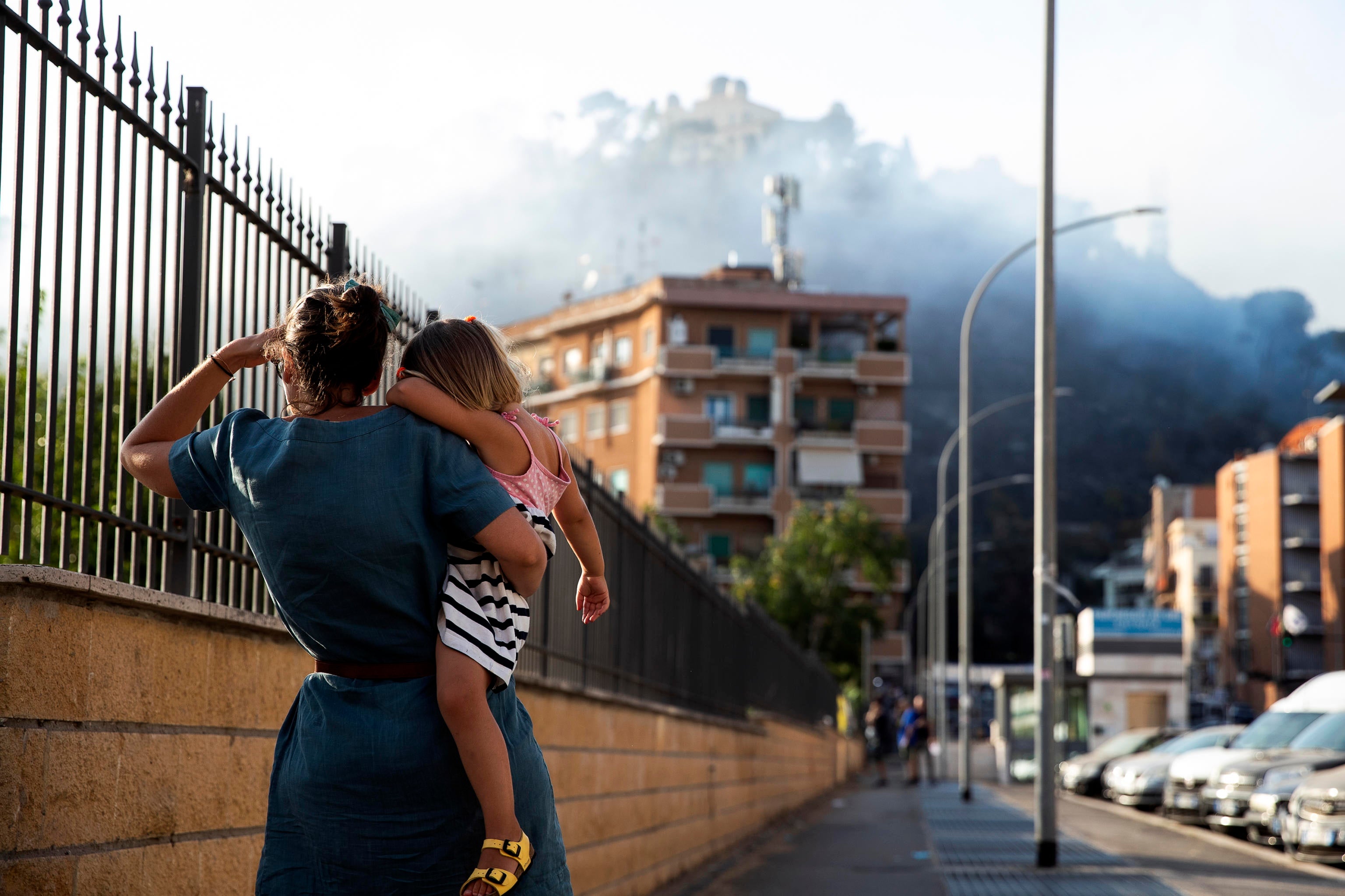 Residents watch a large fire that broke out in the Monte Mario area in Rome, Italy, 31 July 2024