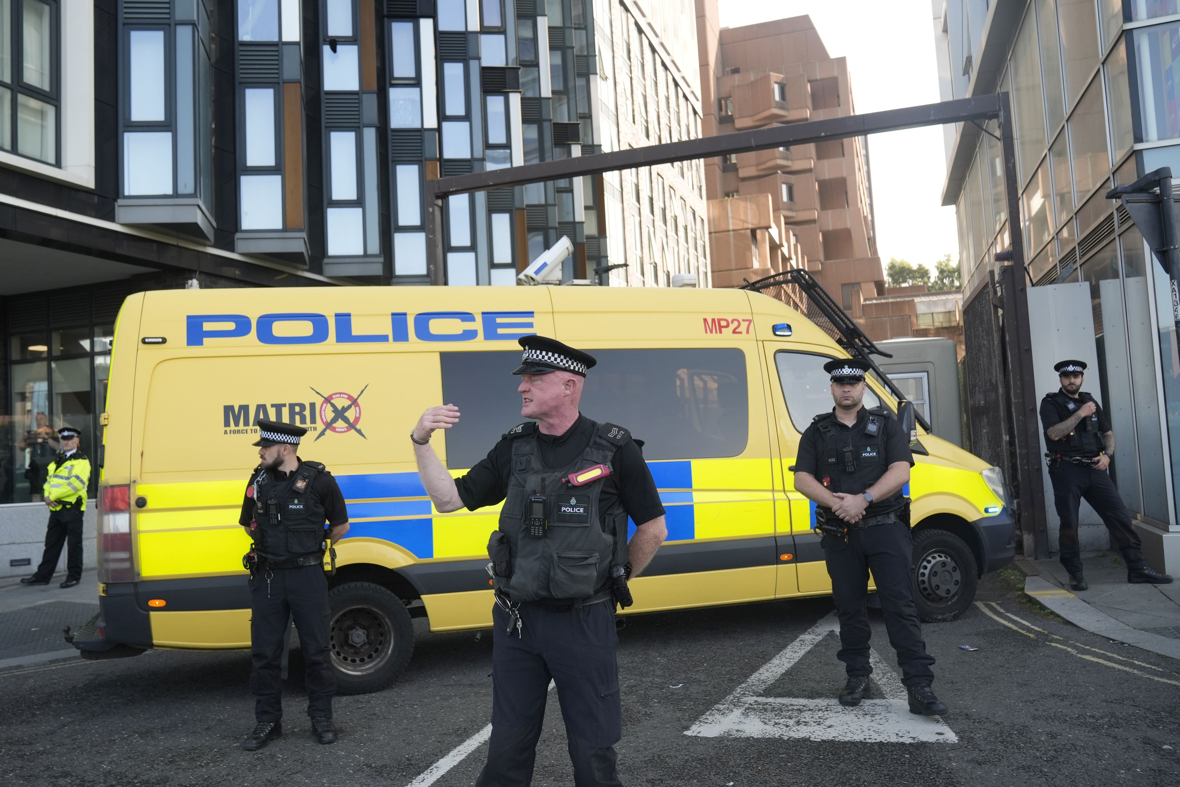 Police officers and a police van block the vehicle entrance at Liverpool Magistrates’ Court ahead of a teenager appearing in the dock charged with murder over the Southport stabbings (Danny Lawson/PA).