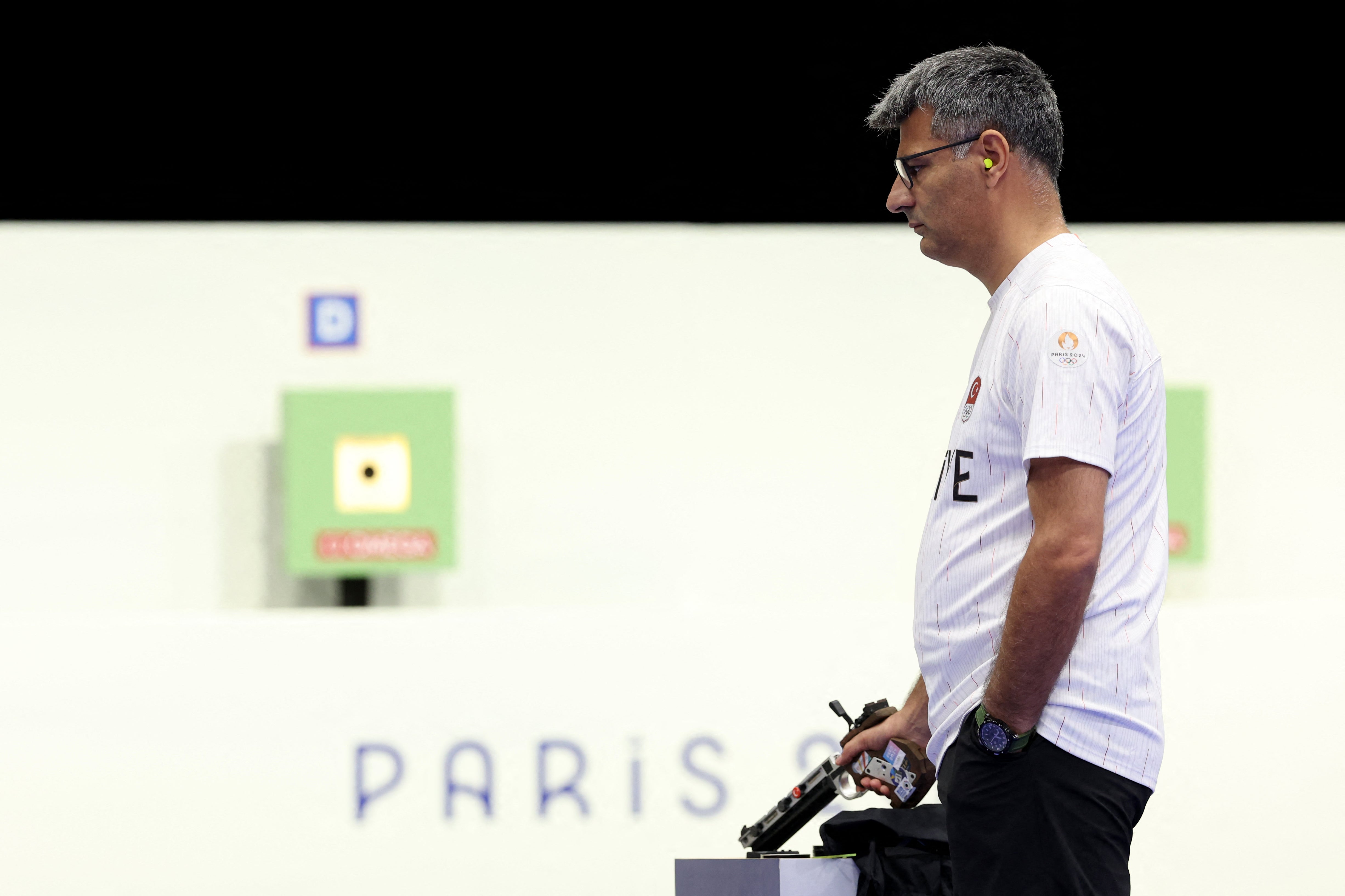 Yusuf Dikec competes in the 10m air pistol mixed team gold medal match at the Paris Olympic