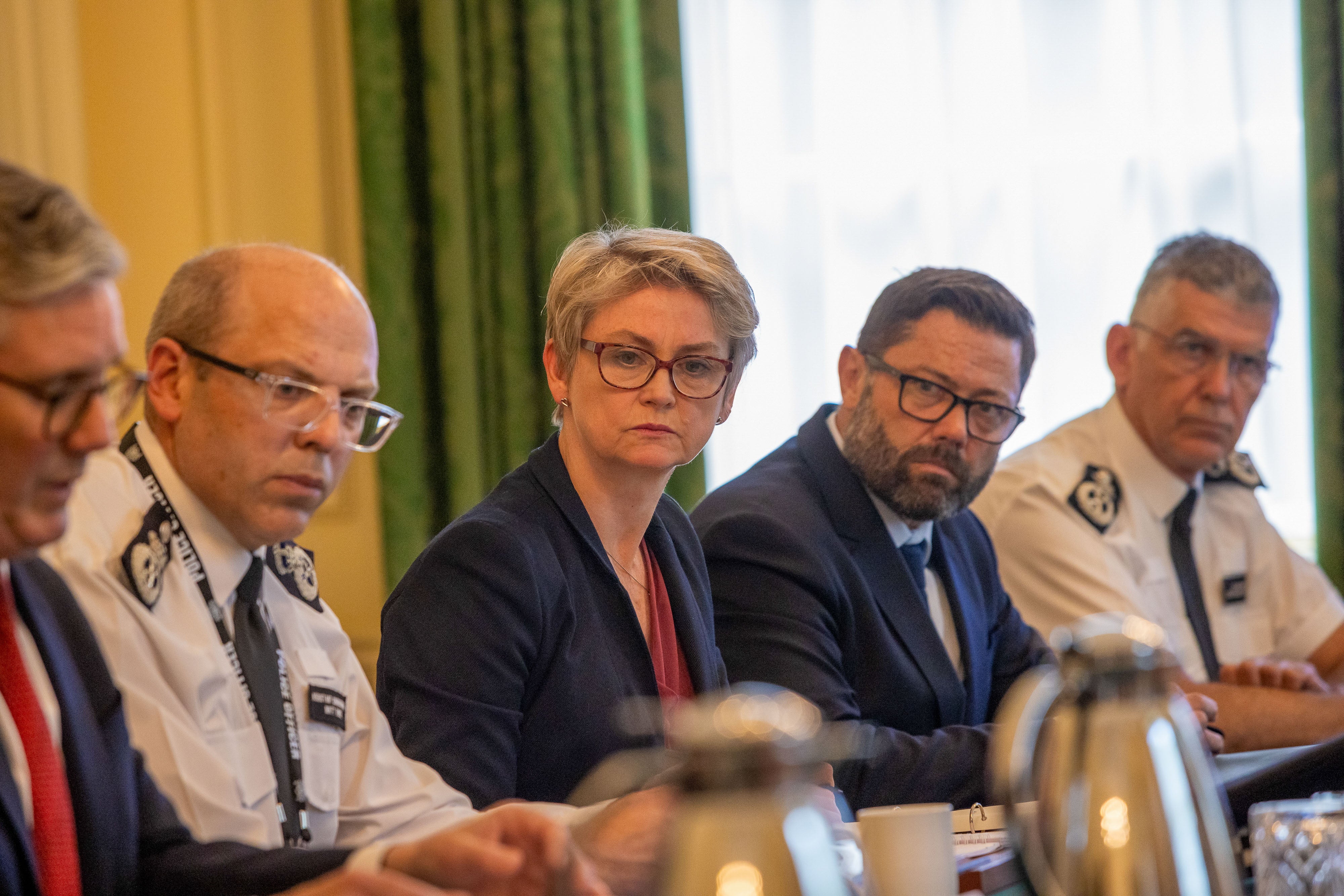 British Home Secretary Yvette Cooper (C) and British Prime Minister Keir Starmer (L) meet with senior policing leaders at Downing Street after far-right demonstrations in Southport, the town where the three girls were killed on 29 July