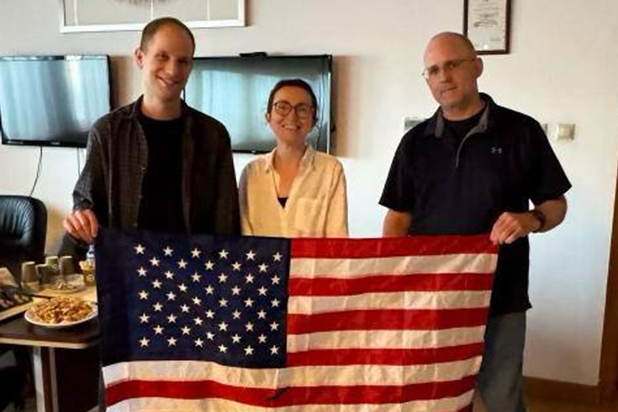 L-R: Evan Gershkovich, Alsu Kurmasheva, and Paul Whelan in first pic released after their release in a prisoner swap between Russia and several countries including the US