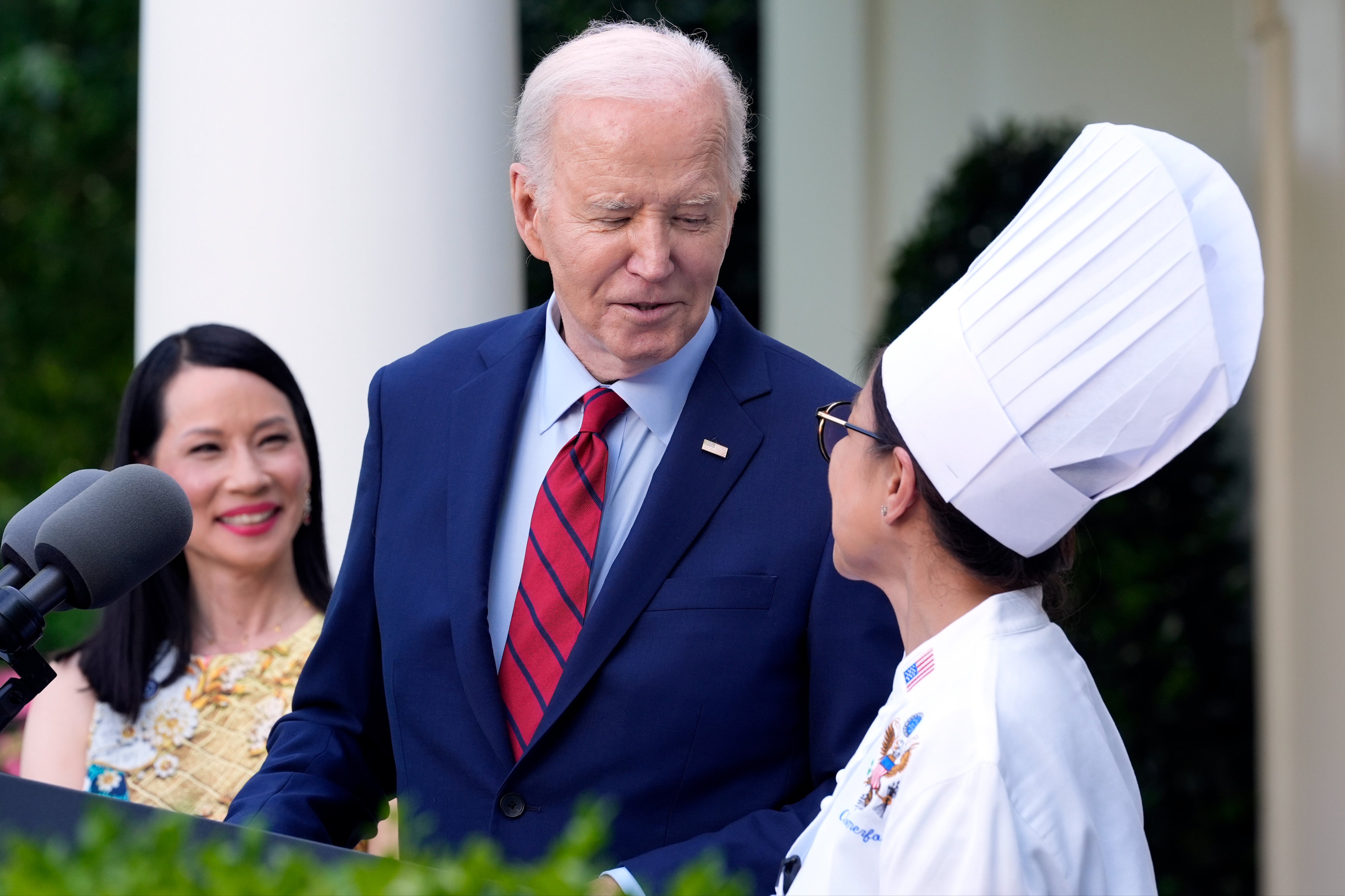 Comerford, pictured with actress Lucy Liu (left) and Joe Biden, has also served under the adminstrations of Bill Clinton, George Bush, Barack Obama and Donald Trump