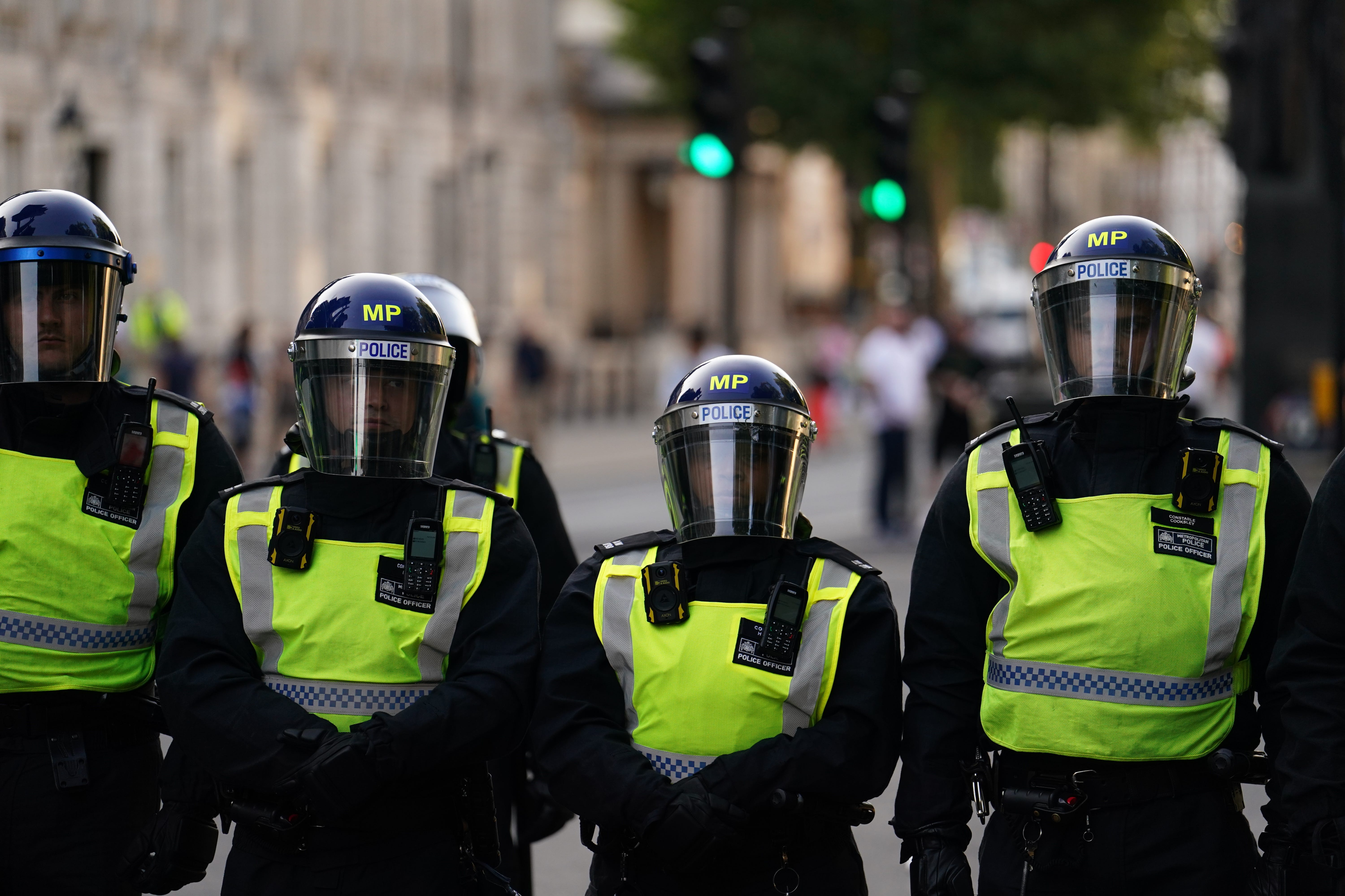 Police officers look on as people attend the ‘Enough is Enough’ protest in Whitehall, London (Jordan Pettitt/PA)