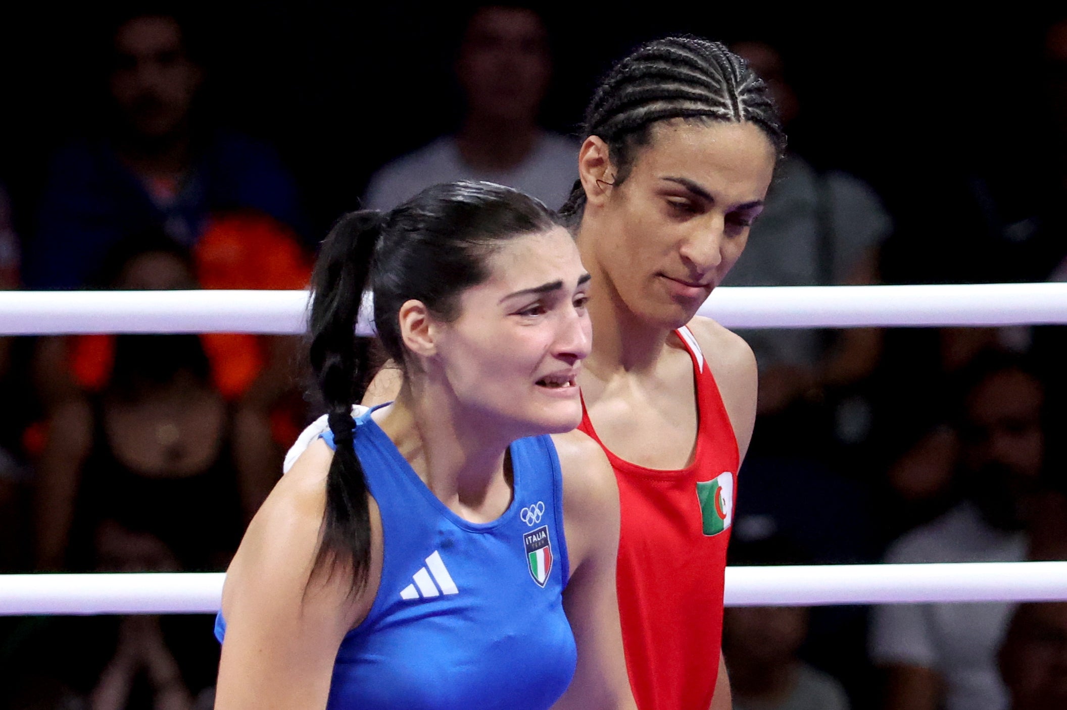 Angela Carini abandons her bout against Imane Khelif (R)