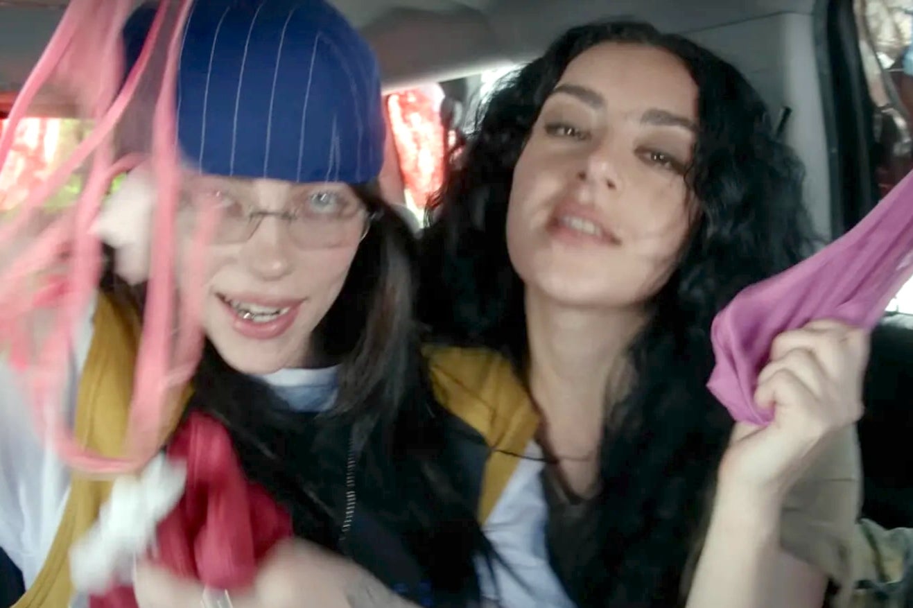 Billie Eilish (left) and Charli XCX in the music video for ‘Guess’