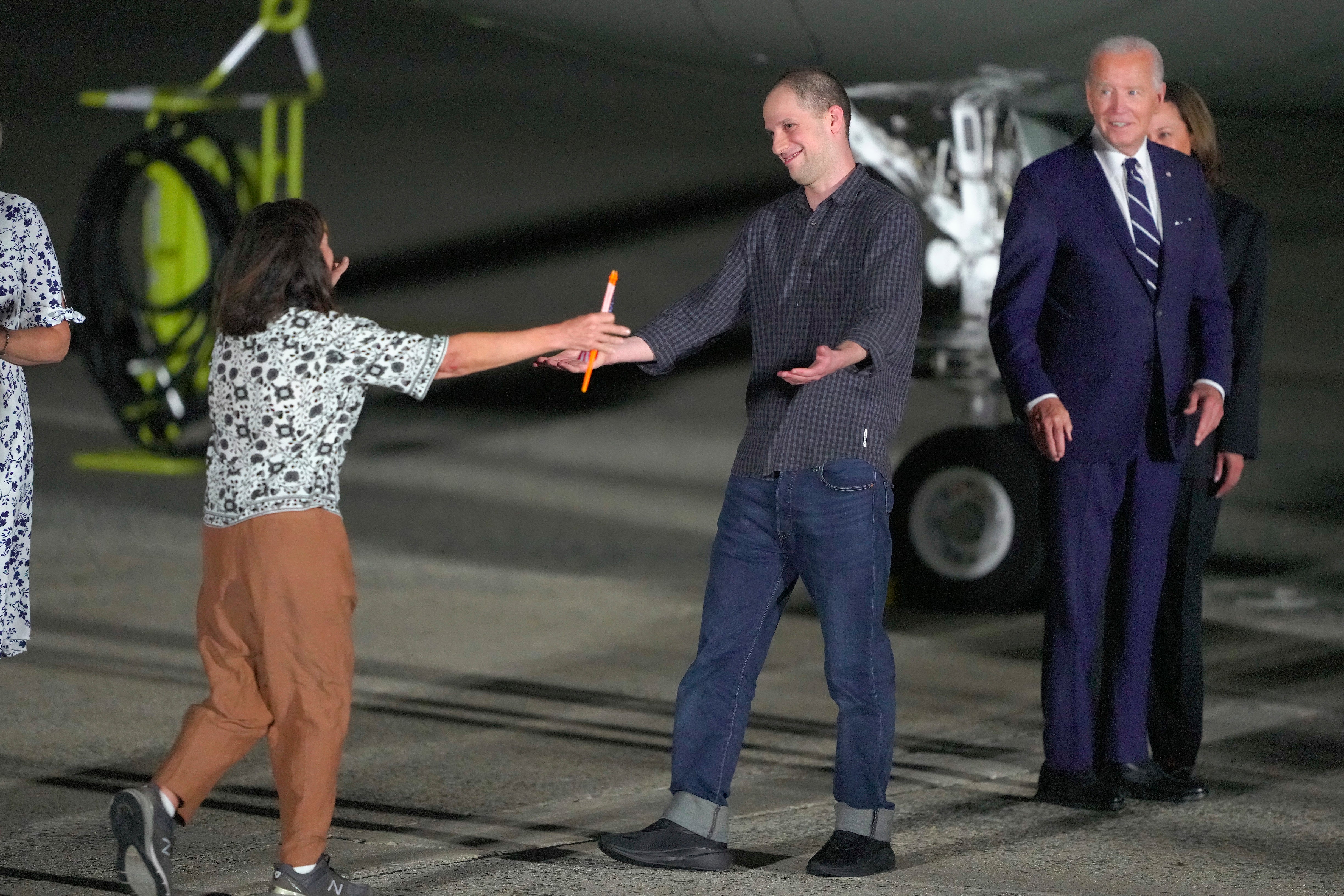 Evan Gershkovich greets his mother Ella Milman as Biden and Harris look on