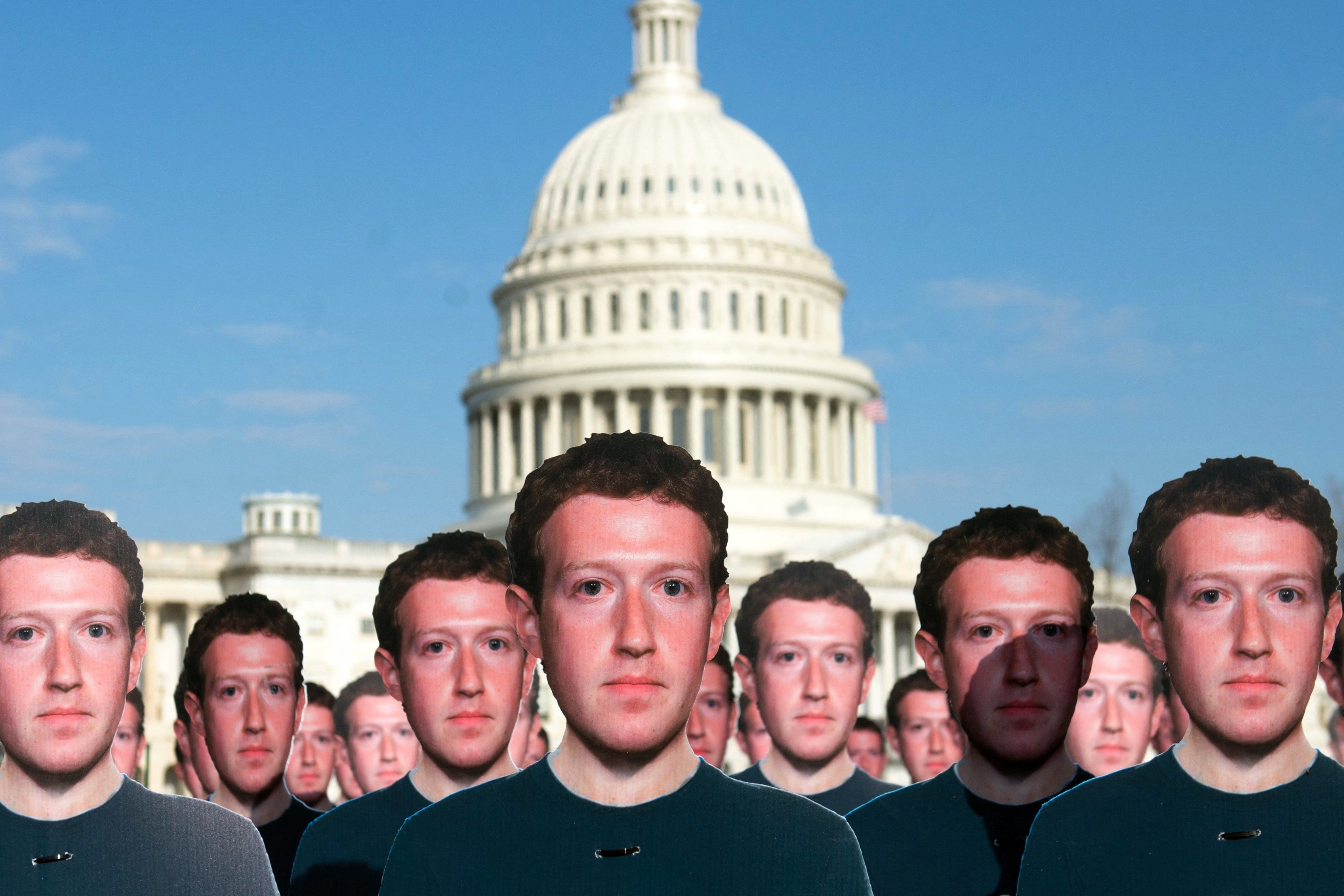 Cardboard cutouts of Facebook founder and CEO Mark Zuckerberg outside the US Capitol in Washington, DC, 10 April, 2018