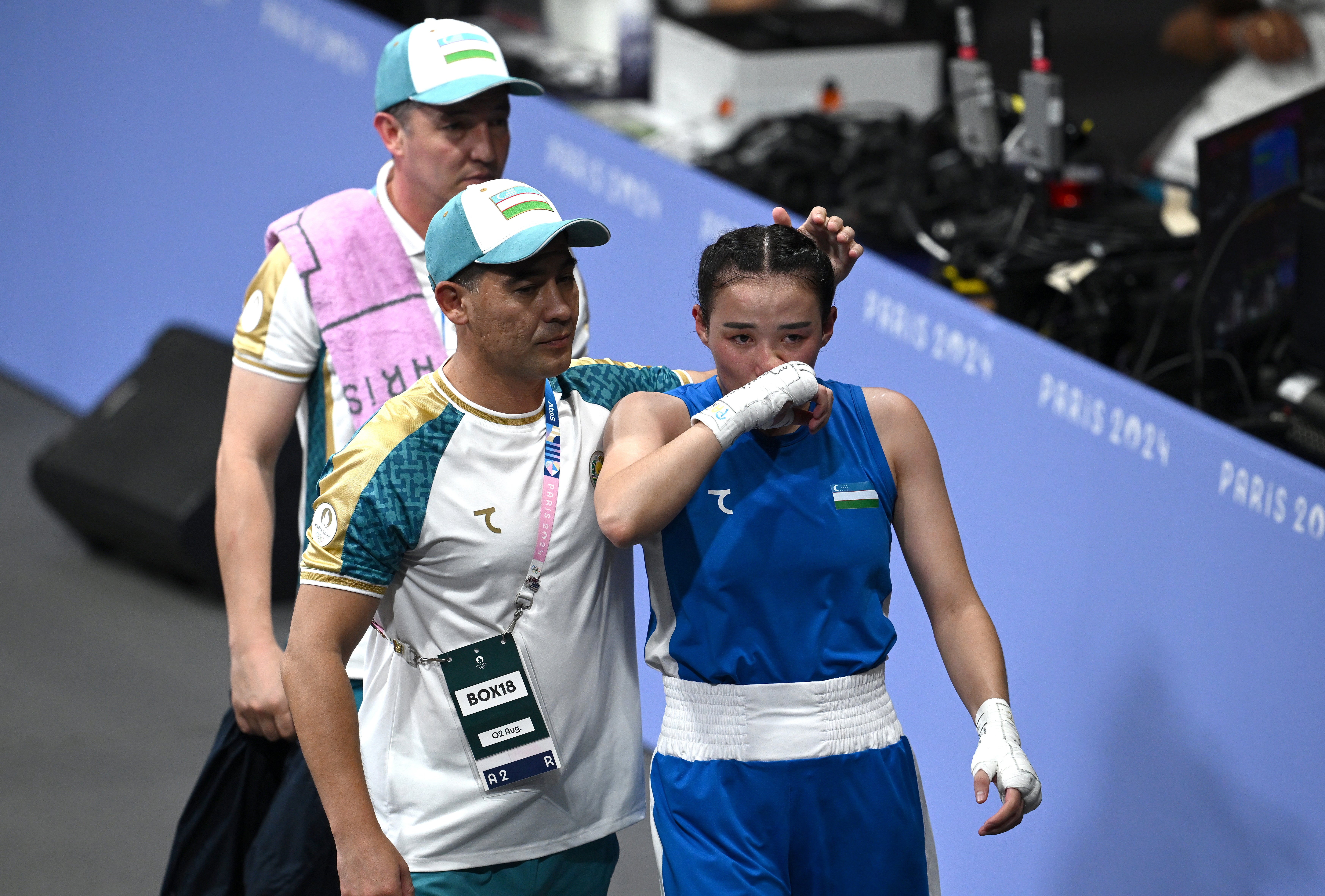 Sitora Turdibekova of Uzbekistan walks off after being defeated by Lin of Taiwan