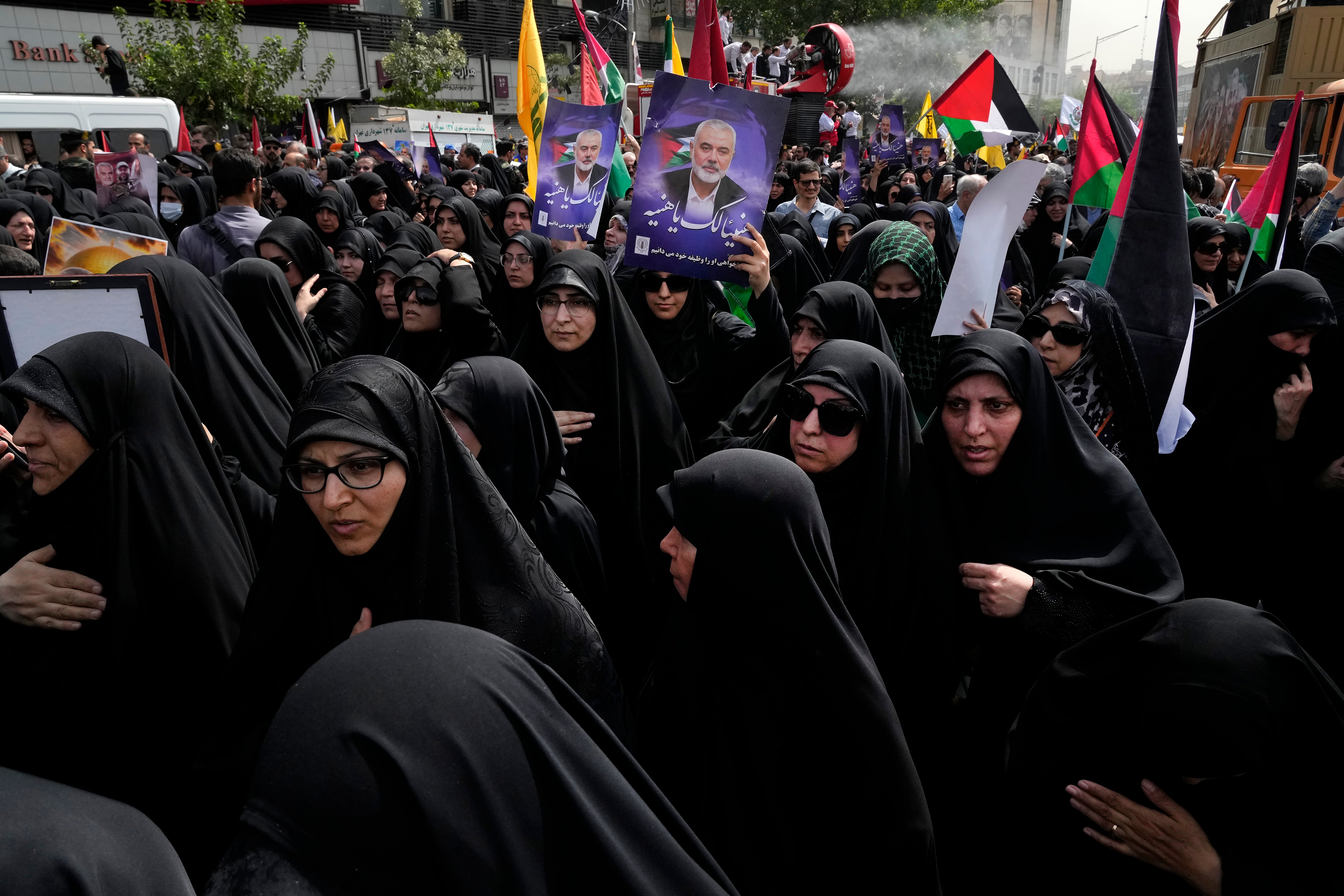 Iranians attend the funeral ceremony of Hamas leader Ismail Haniyeh and his bodyguard, some of them holding up posters with his photo and reading in Arabic: "Congratulations Haniyeh!" at Enqelab-e-Eslami (Islamic Revolution) Sq. in Tehran, Iran, 1 Aug 2024