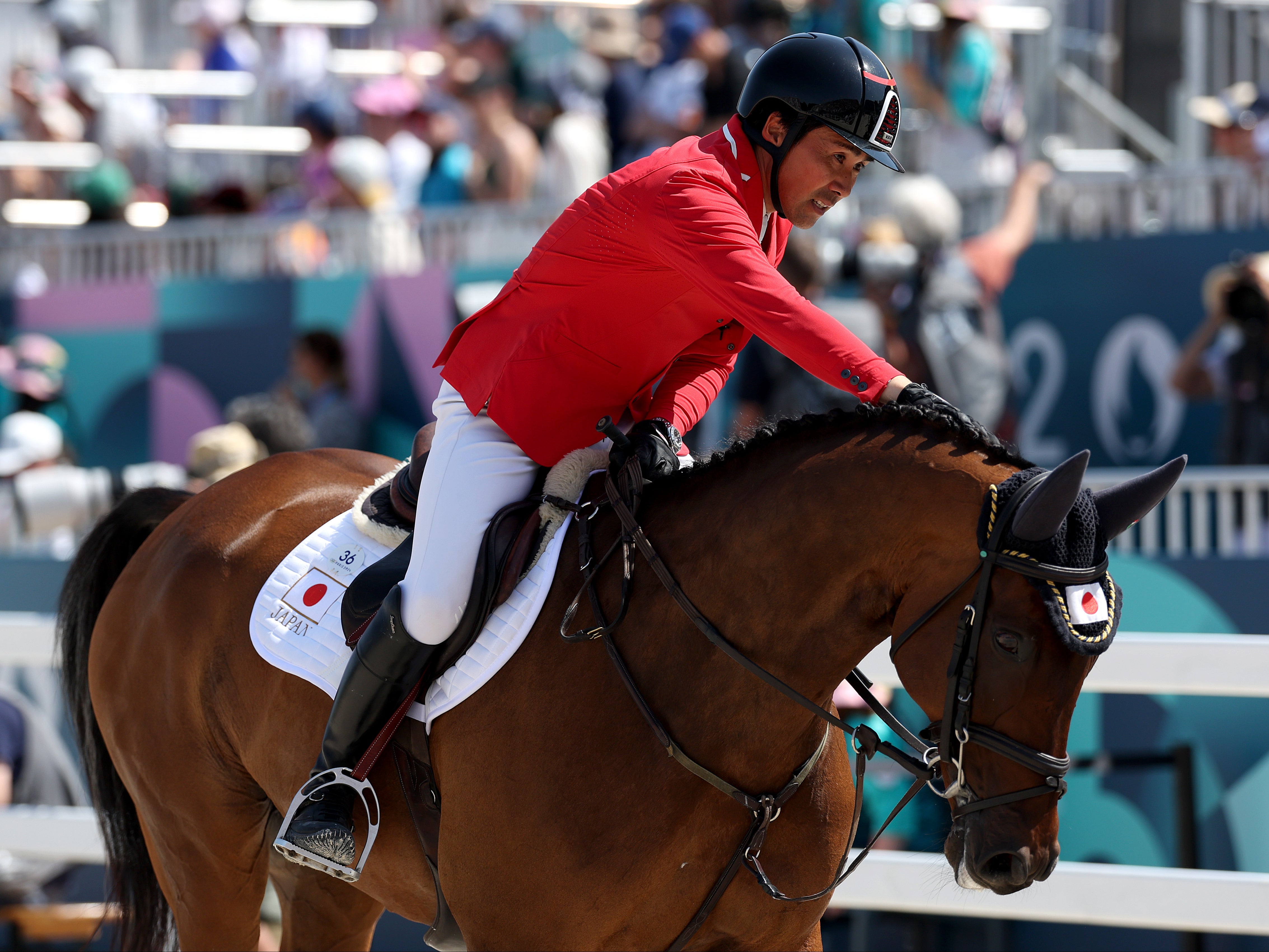 Yoshiaki Oiwa interacts with horse MGH Grafton Street of Team Japan at the 2024 Paris Olympics