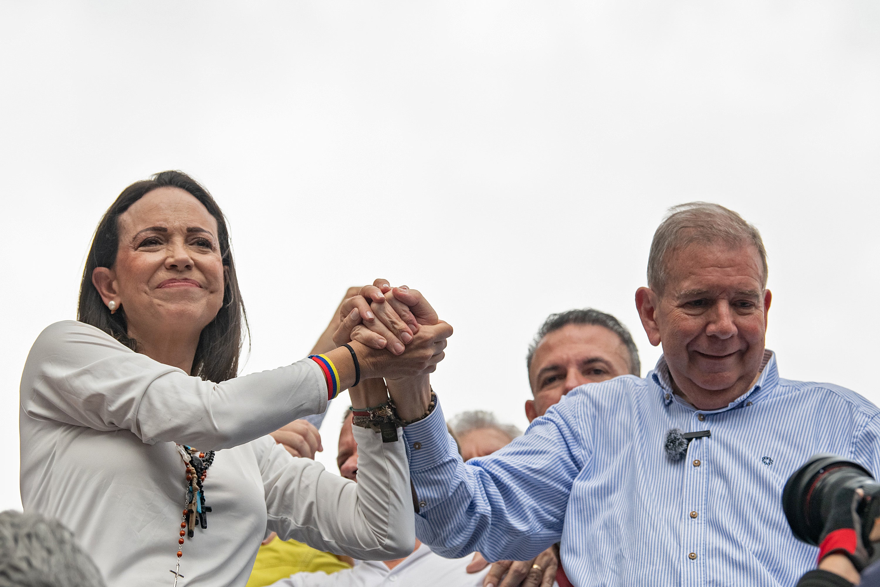 Machado and Gonzalez join hands during a protest against the result of the presidential election last year
