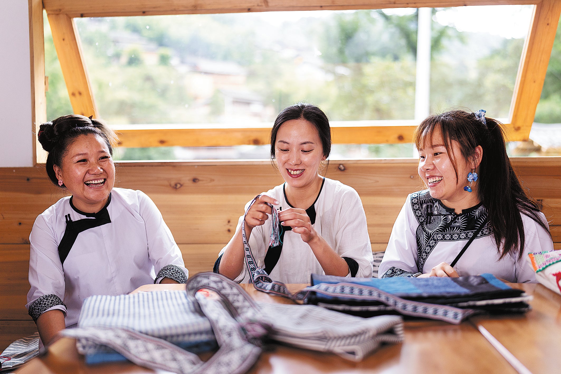 Designer Jenny Chou (middle) working with women at a cooperative she founded in the village