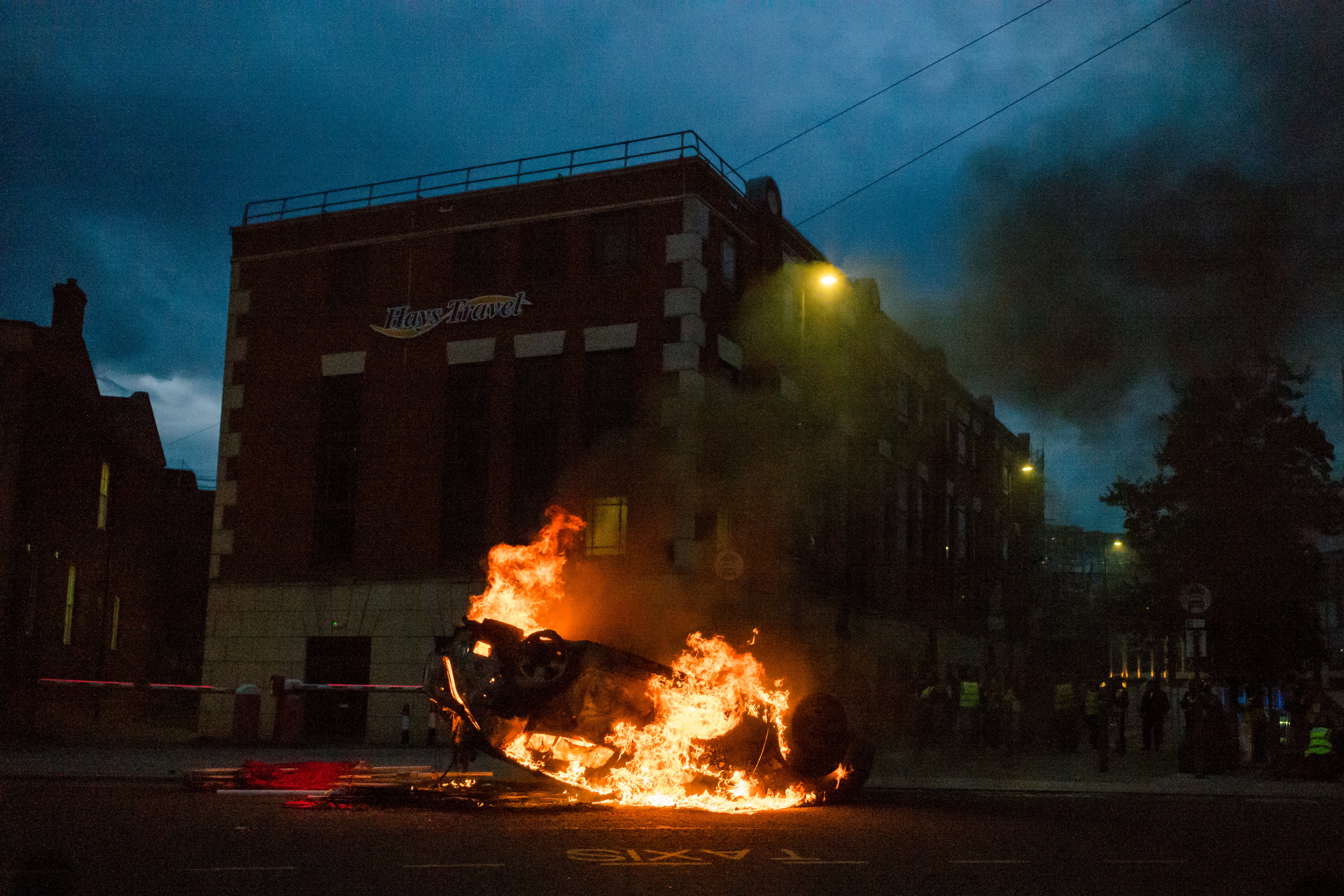 A police car is set on fire by far-right protesters in Sunderland