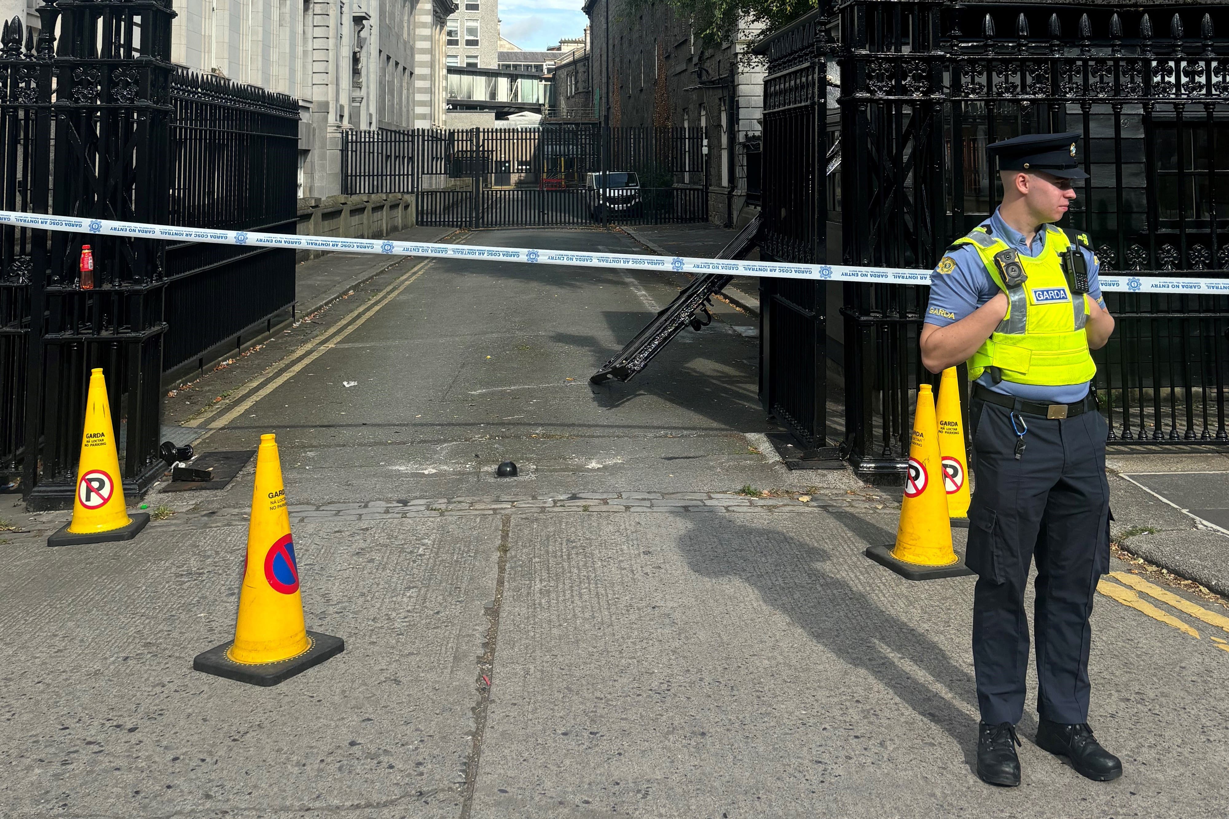 Garda at the scene after a vehicle drove into gates at Government Buildings in Dublin (Cate McCurry/PA)