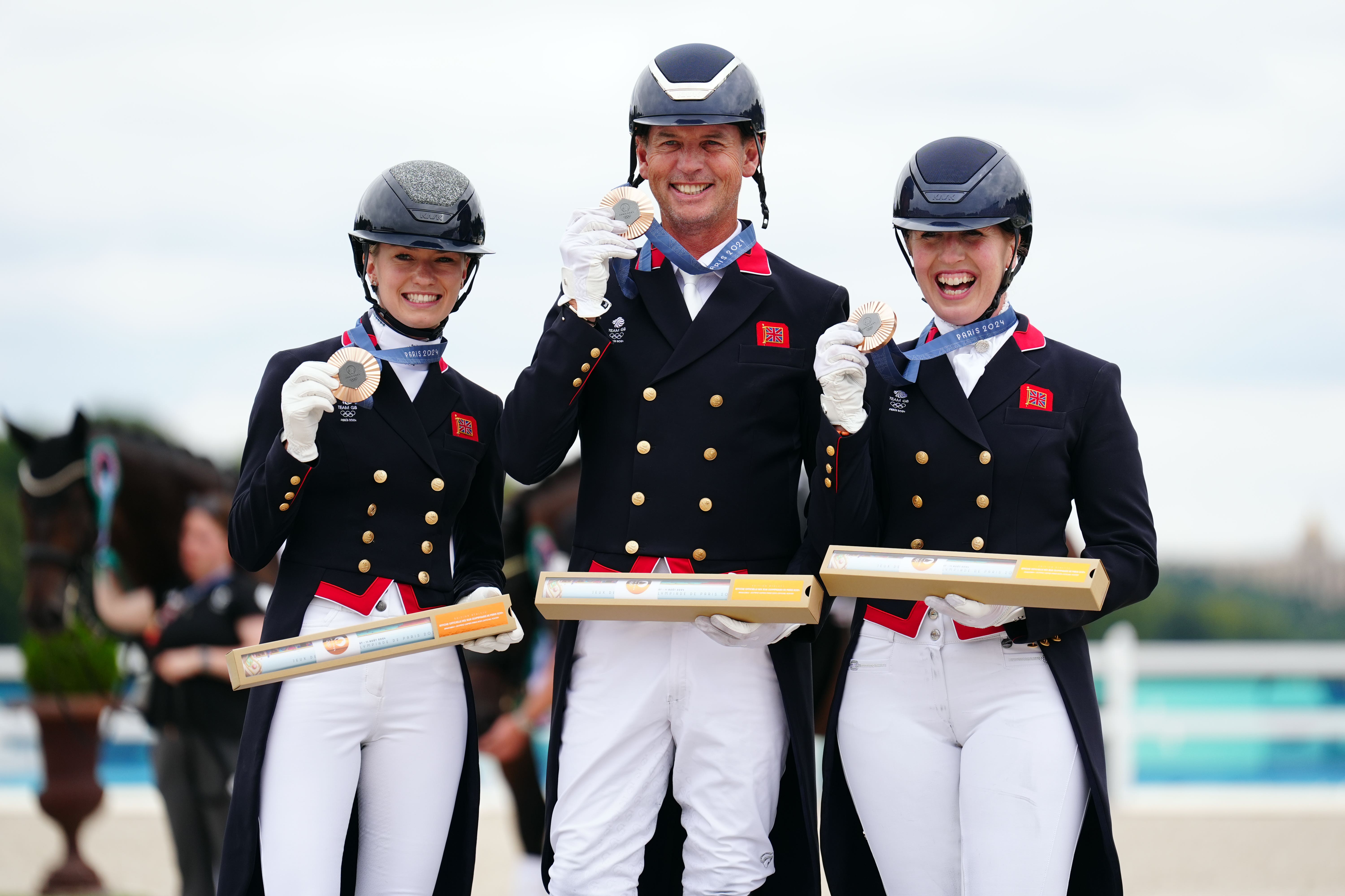 Great Britain’s Charlotte Fry, Carl Hester and Becky Moody after winning a bronze medal in the team dressage final (Mike Egerton/PA)