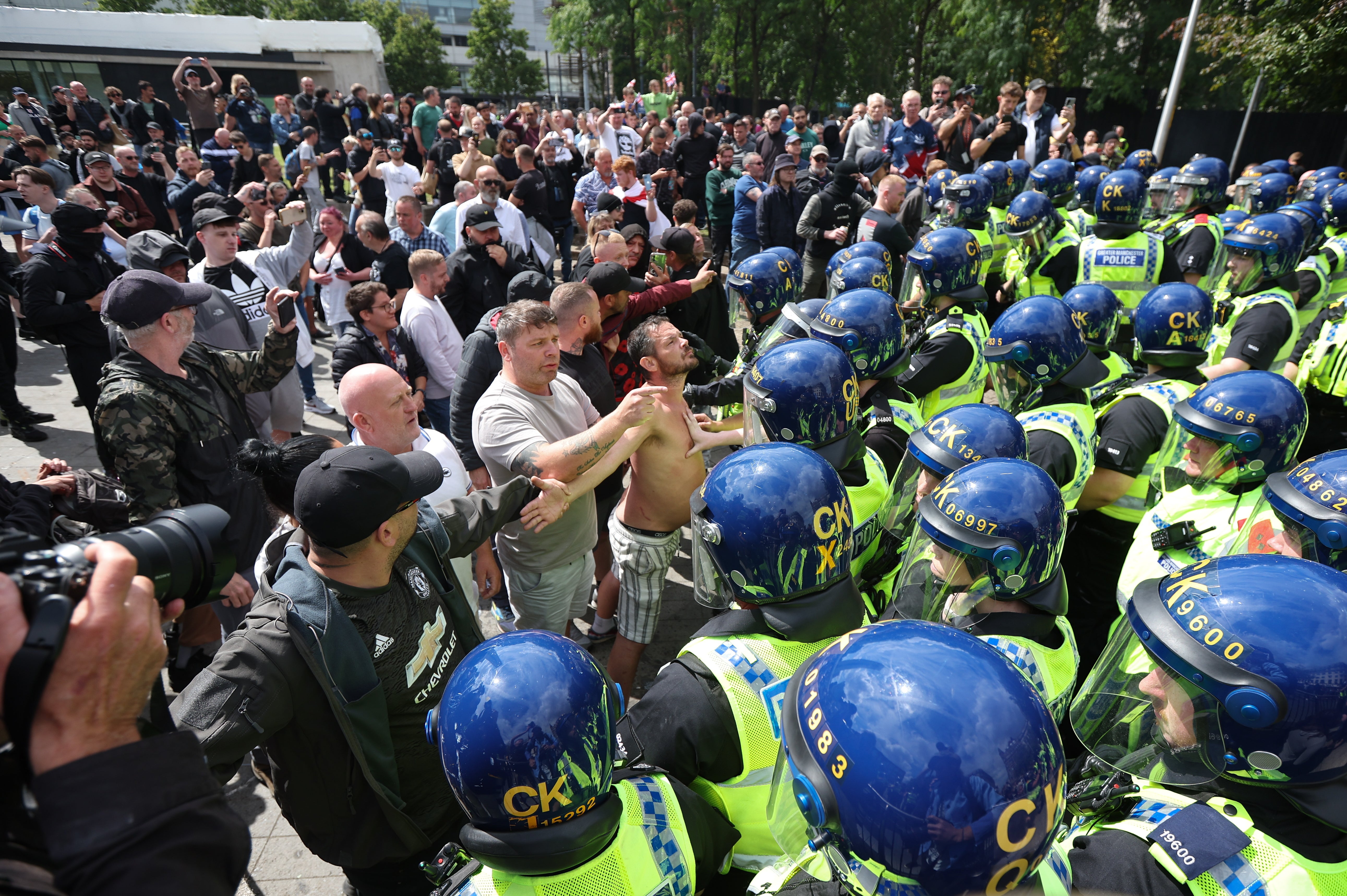 Protesters confront police officers in Manchester