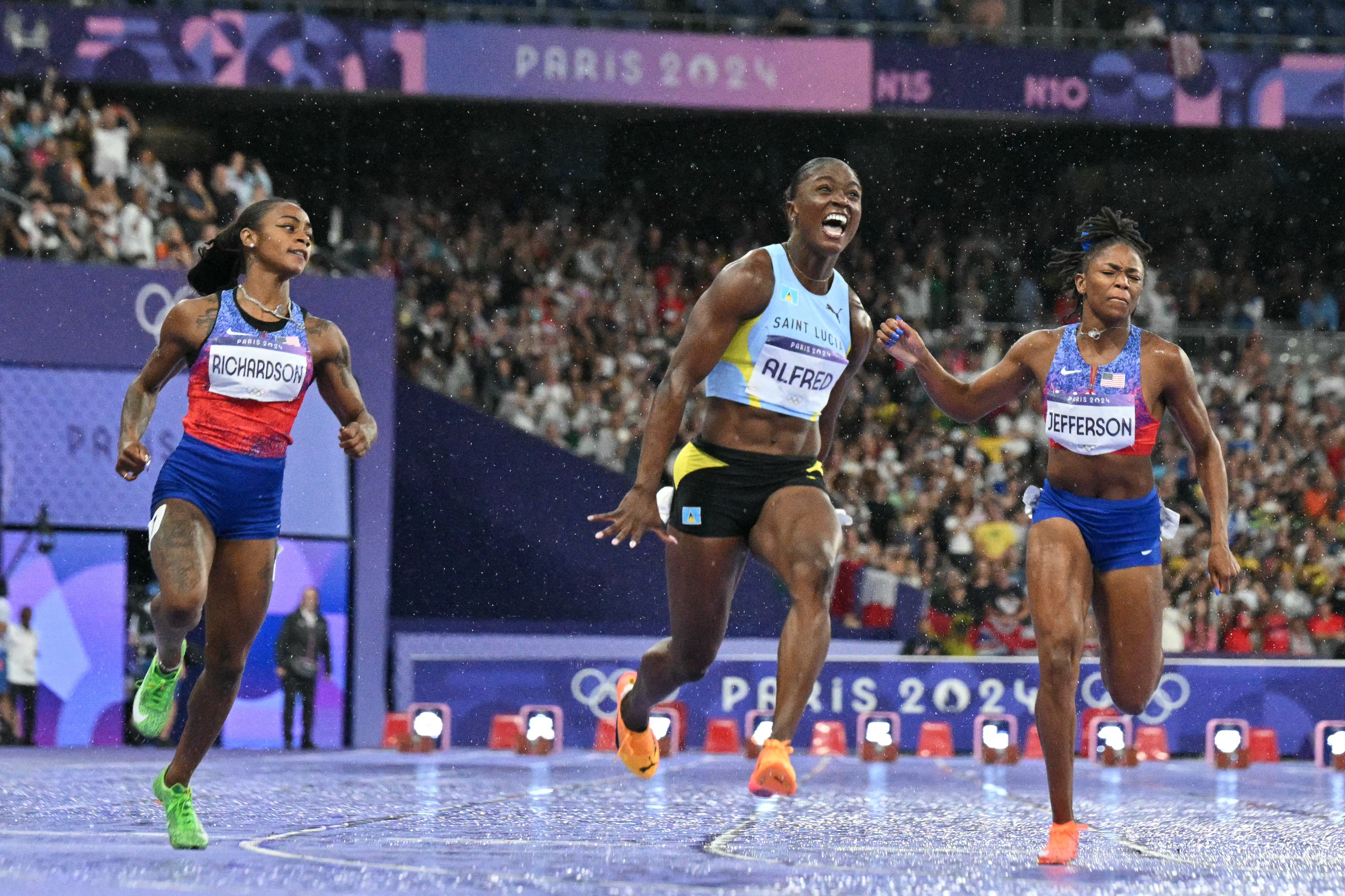 Julien Alfred crosses the line to clinch Olympic gold