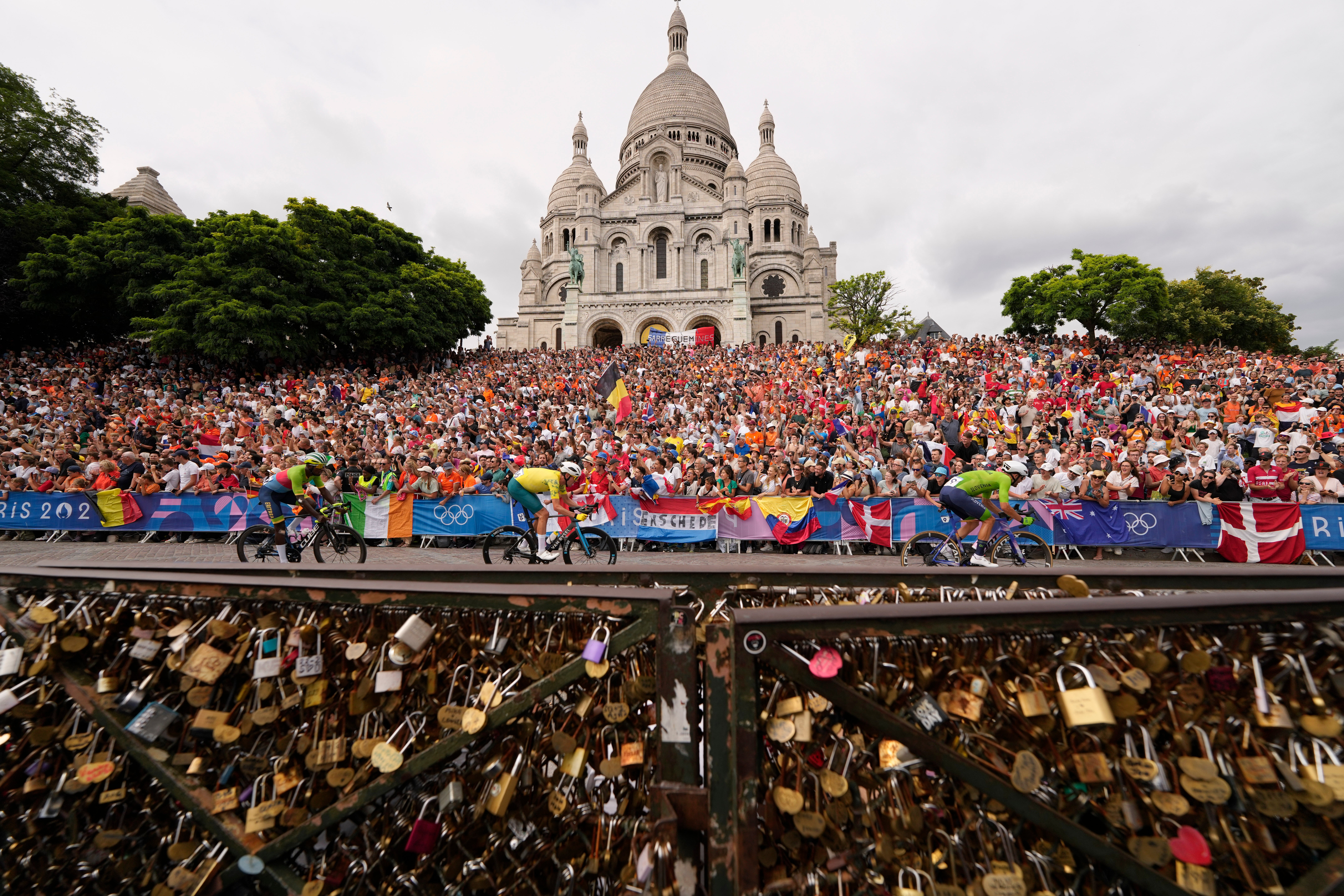 Cyklisté jezdí kolem baziliky Sacre Coeur během pánské silniční cyklistiky na letní olympiádě 2024