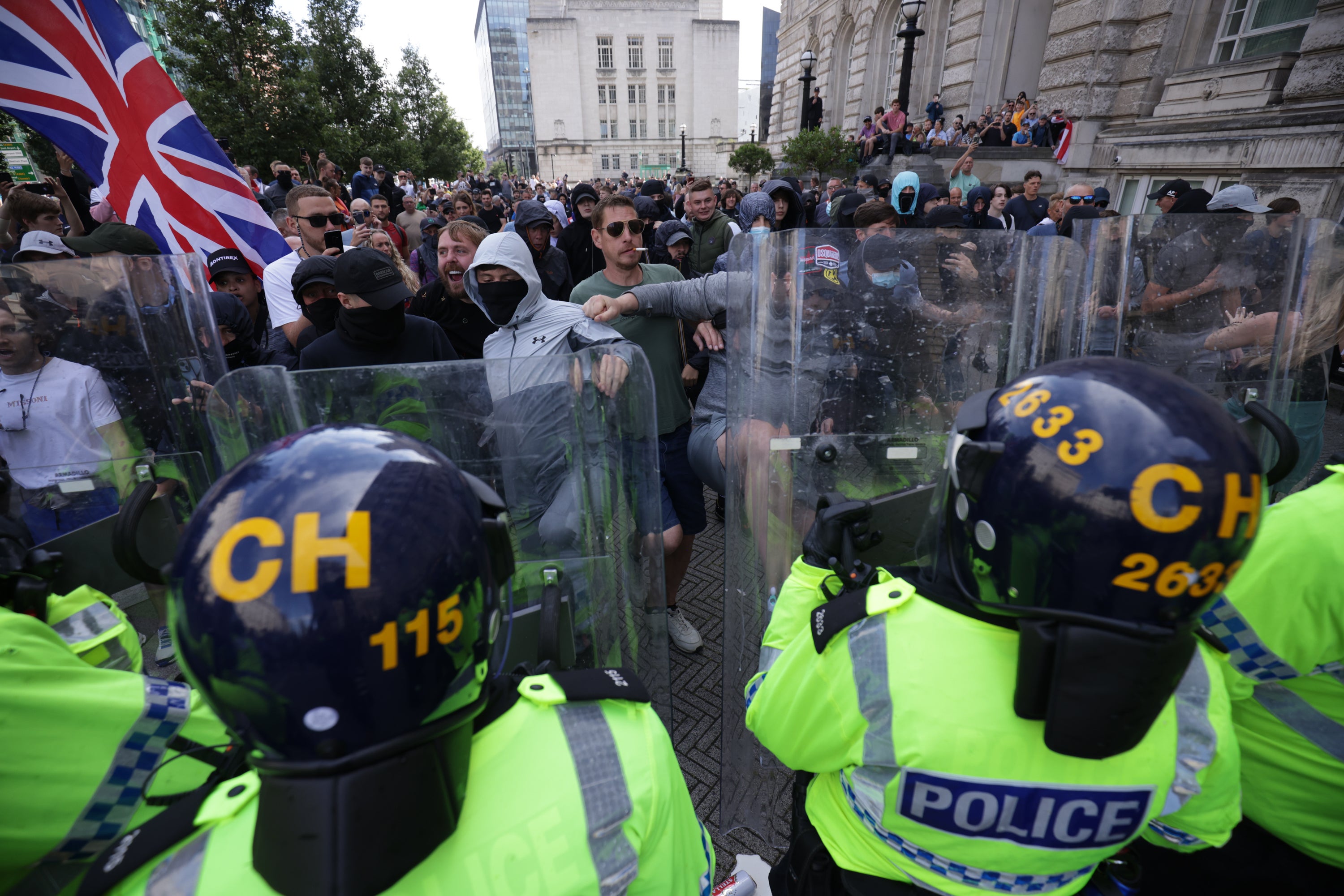 Police officers face protesters in Liverpool as the city was engulfed by far-right riots last week