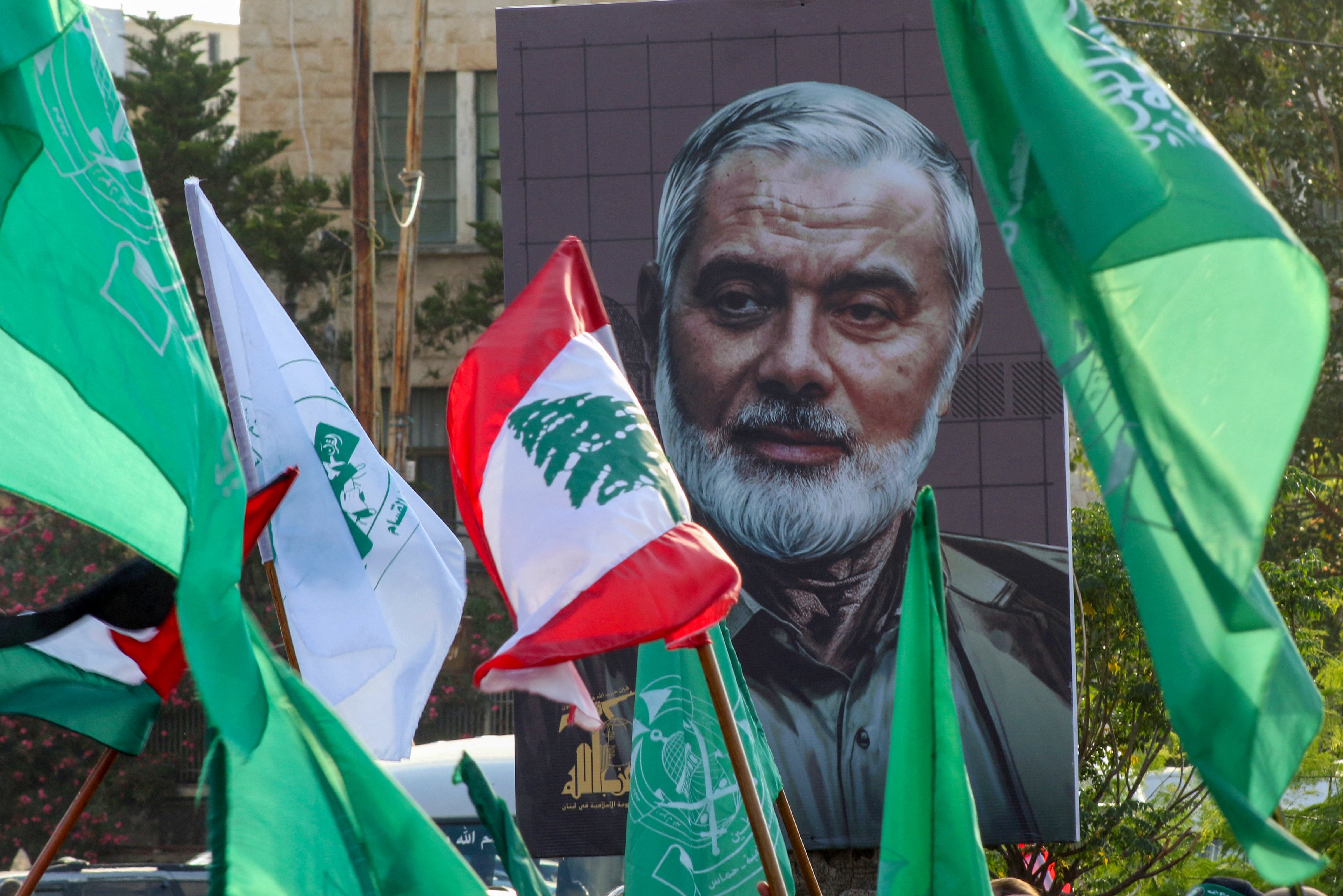 A portrait of the assassinated Hamas leader Ismail Haniyeh is displayed during a demonstration denouncing his killing in the Lebanese coastal city of Sidon