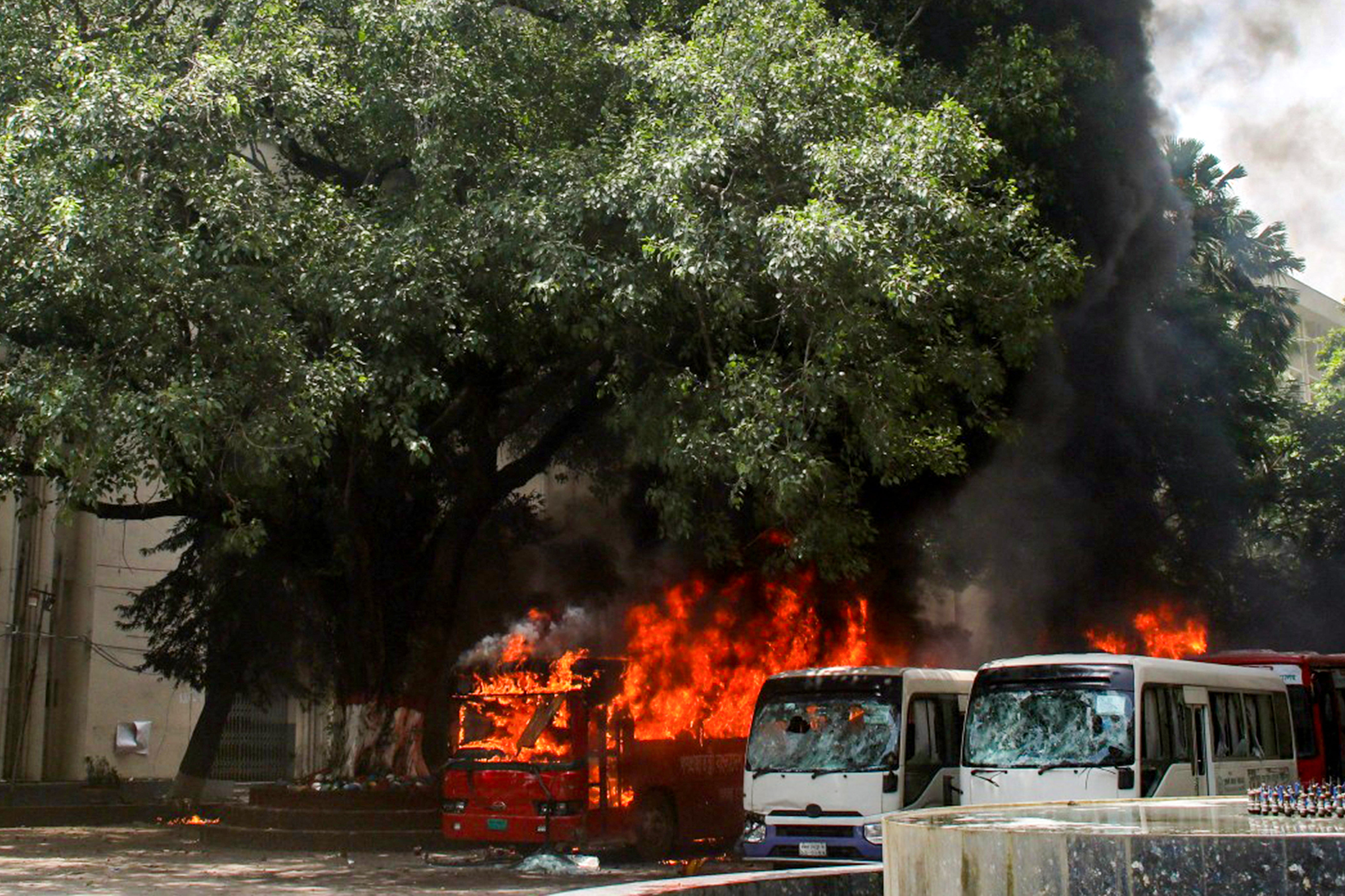 Buses are seen on fire at the Bangabandhu Sheikh Mujib Medical University premises