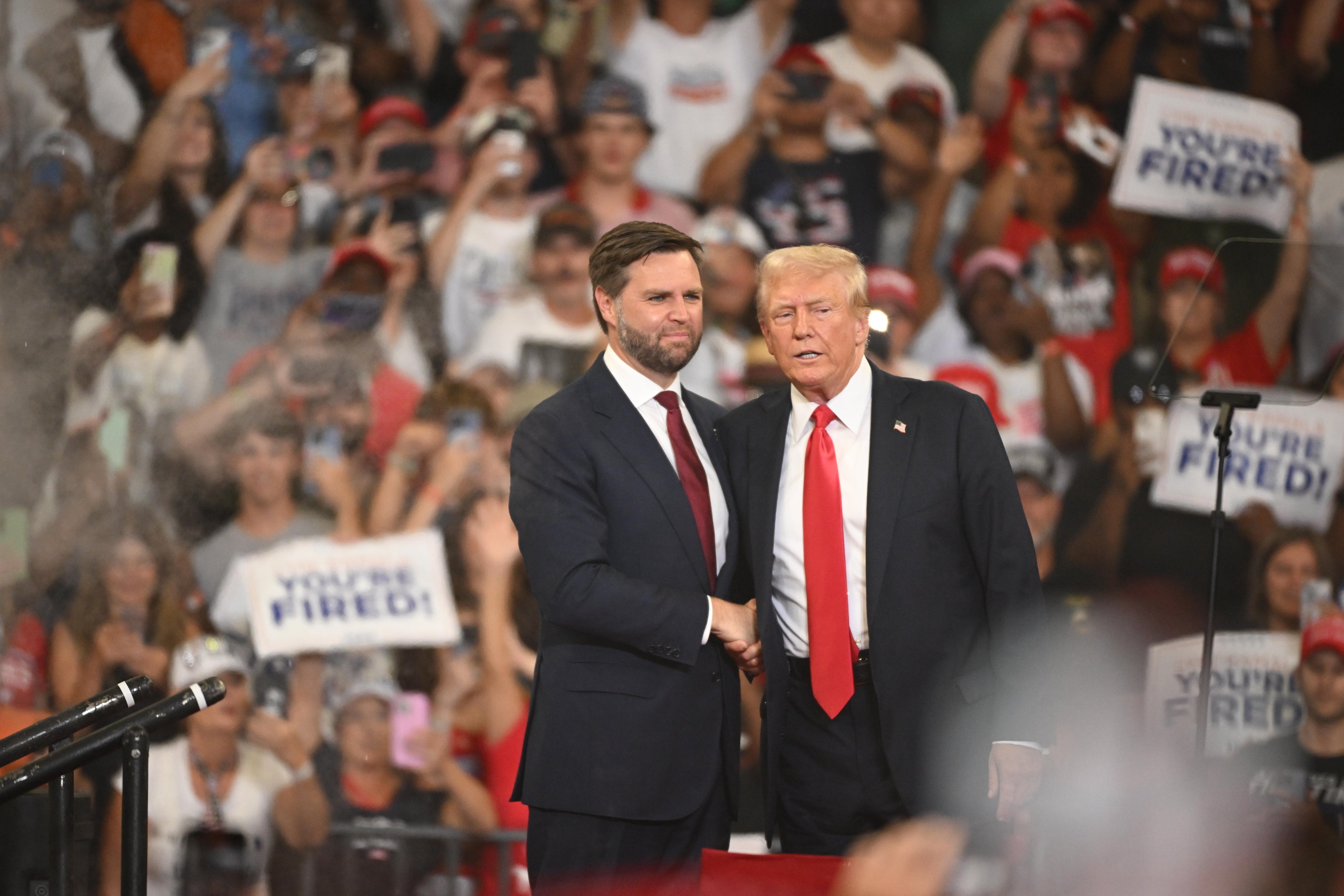 JD Vance (left) and Trump shake hands at a campaign rally. Political strategist Evan Siegfried said Vance has “message discipline,” something that Trump lacks