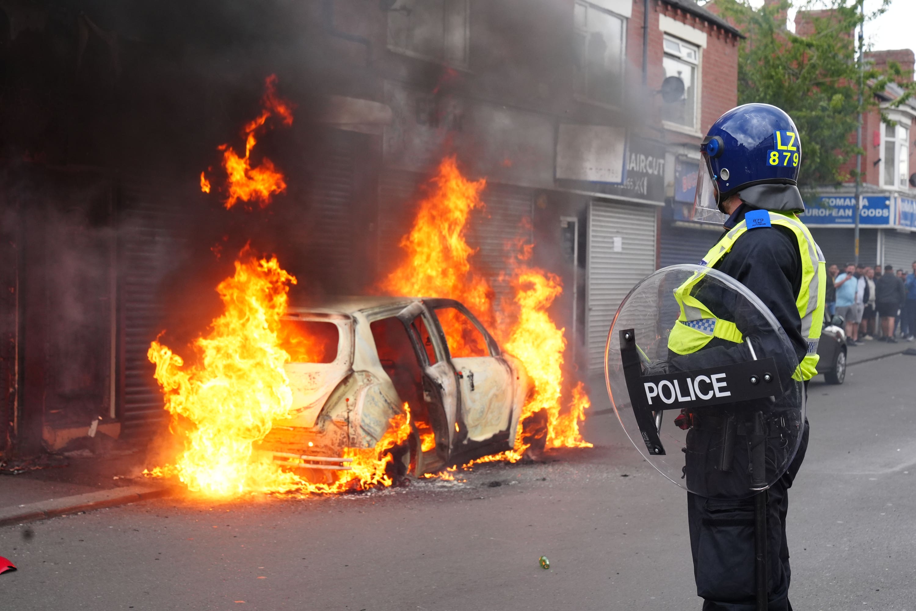 A car burns on Parliament Road, in Middlesbrough, during an anti-immigration protest (Owen Humphreys/PA)