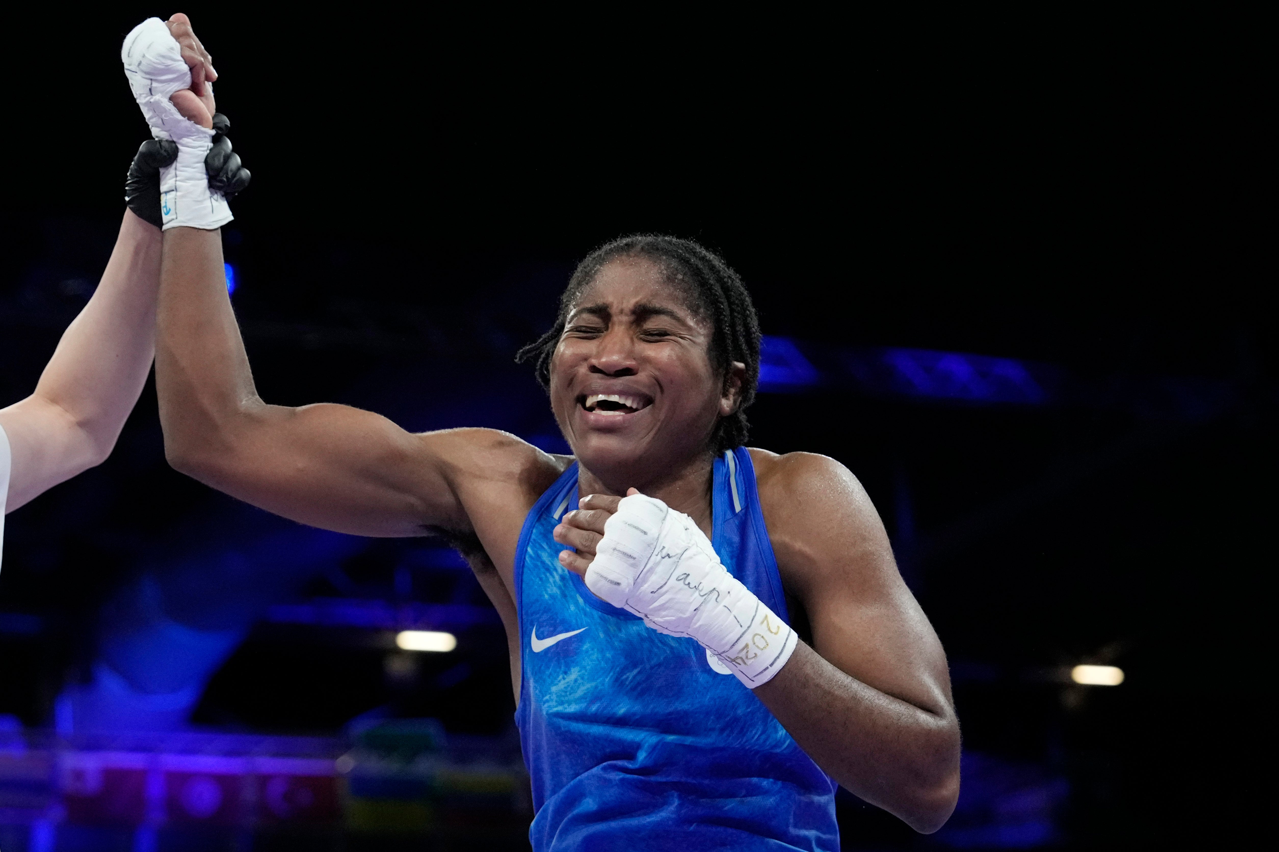 Refugee Olympic Team's Cindy Ngamba celebrates after defeating Canada's Tammara Thibeault