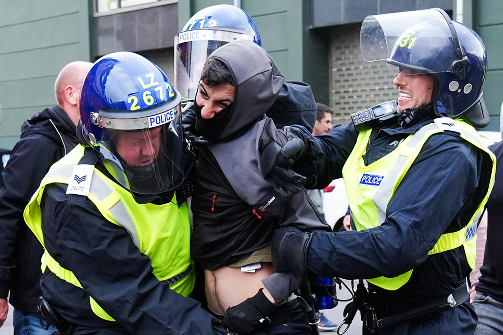 A man is detained by police officers in Middlesbrough
