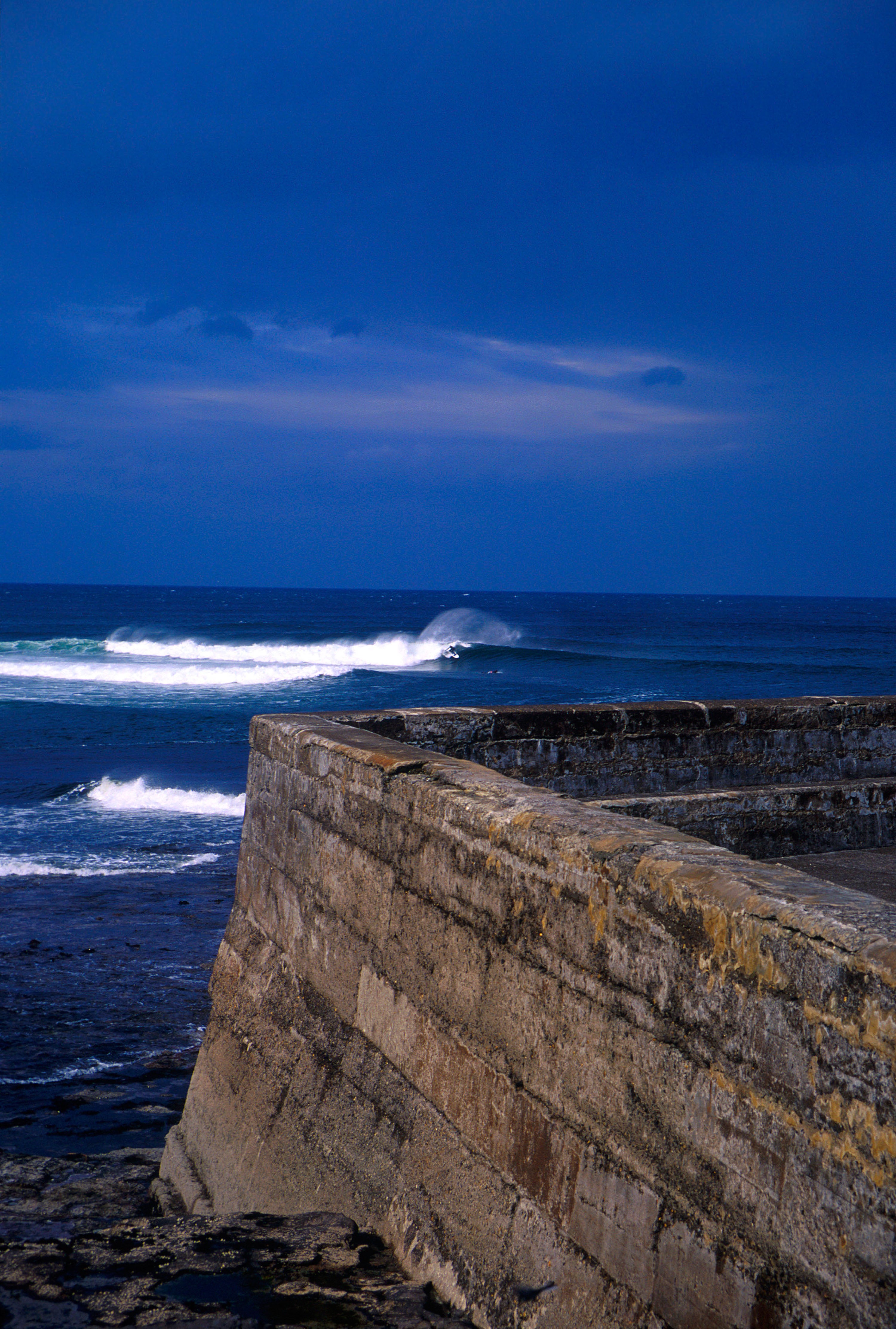 Sky meets the sea: a deep blue surf in one of Ireland’s stop surfing spots