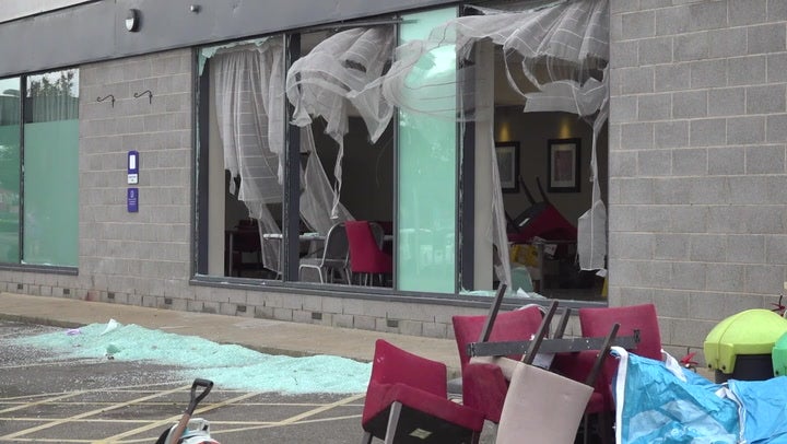 Rotherham riots: Police guard Holiday Inn as residents sweep up glass in mammoth clean-up