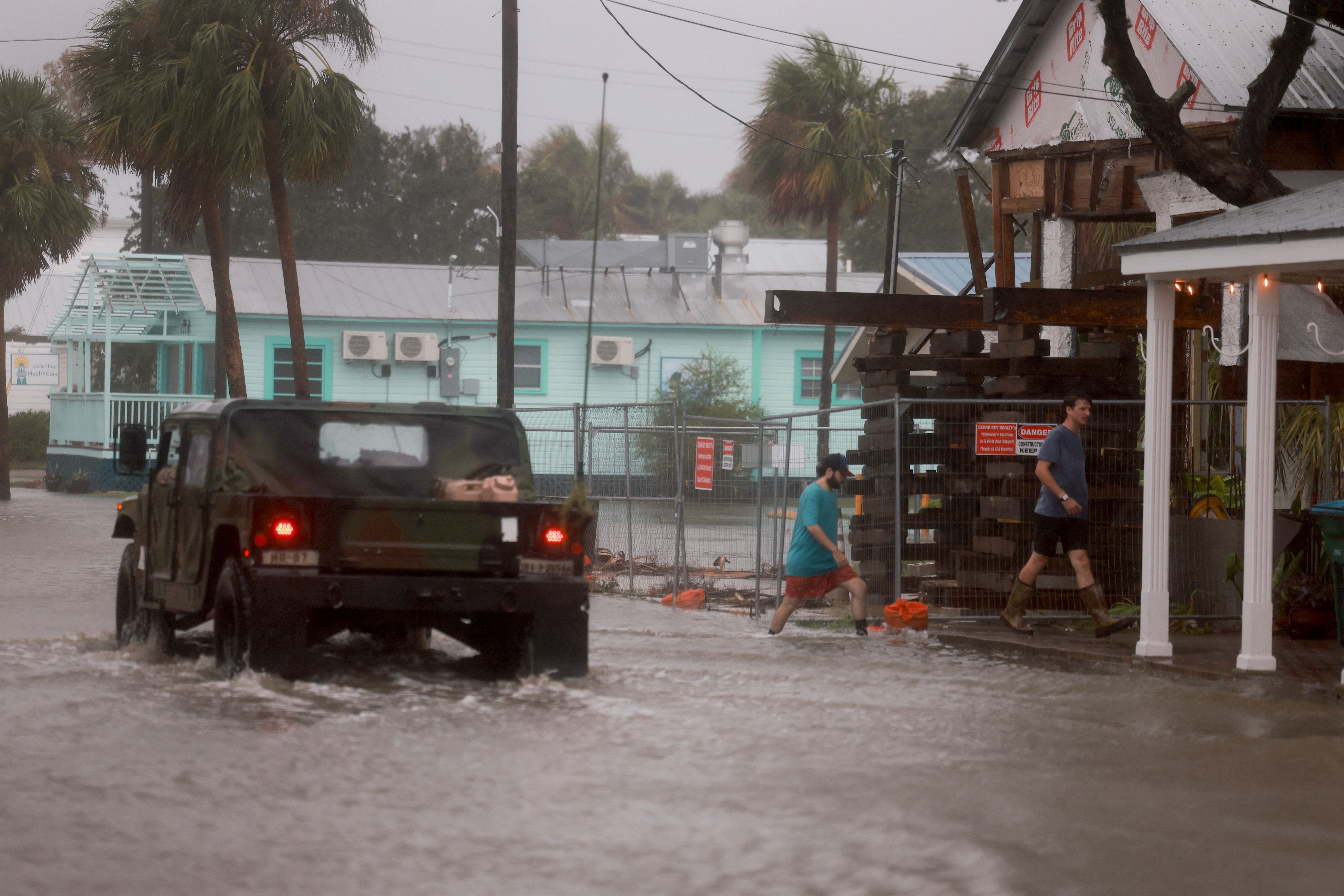 A Florida National Guard vehicle drives through a flooded street caused by the rain and storm surge from Hurricane Debby on August 05, 2024, in Cedar Key, Florida